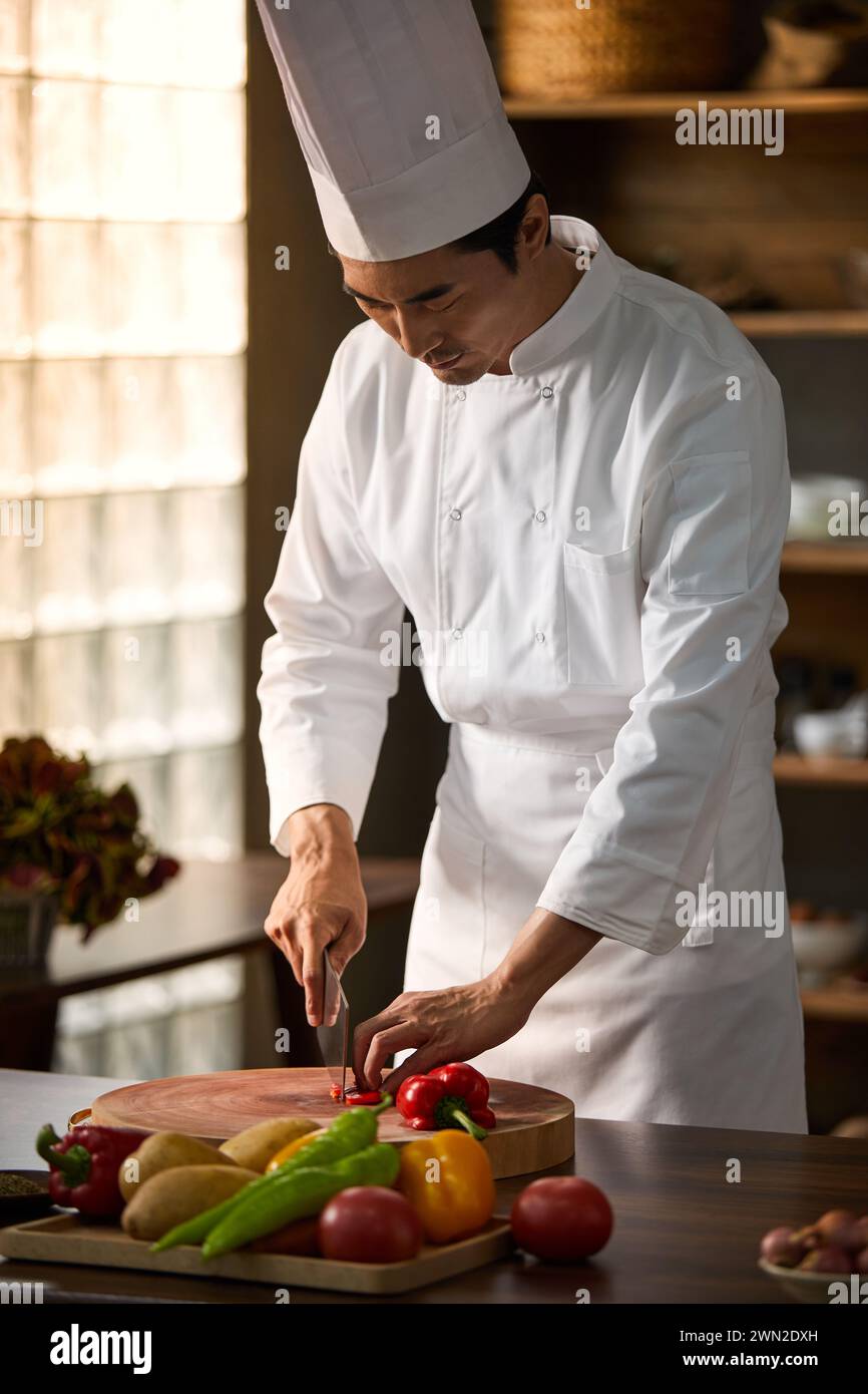 Cook making dishes in the kitchen Stock Photo - Alamy