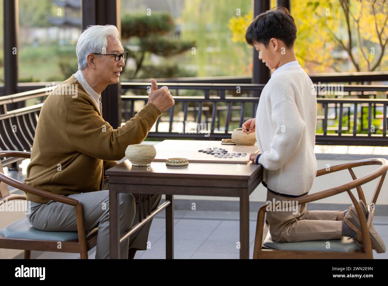 Grandfather and Grandson Playing Go Stock Photo