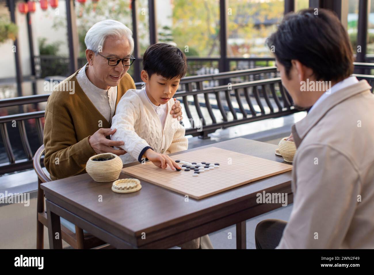 Male Members of the Family Playing Go Stock Photo