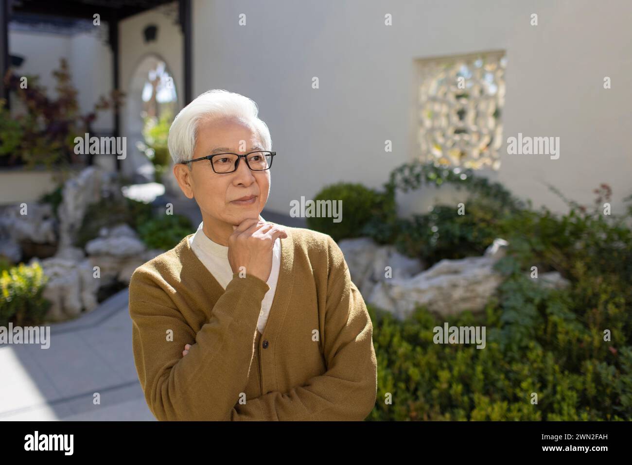 Senior Man in Classical Garden Stock Photo