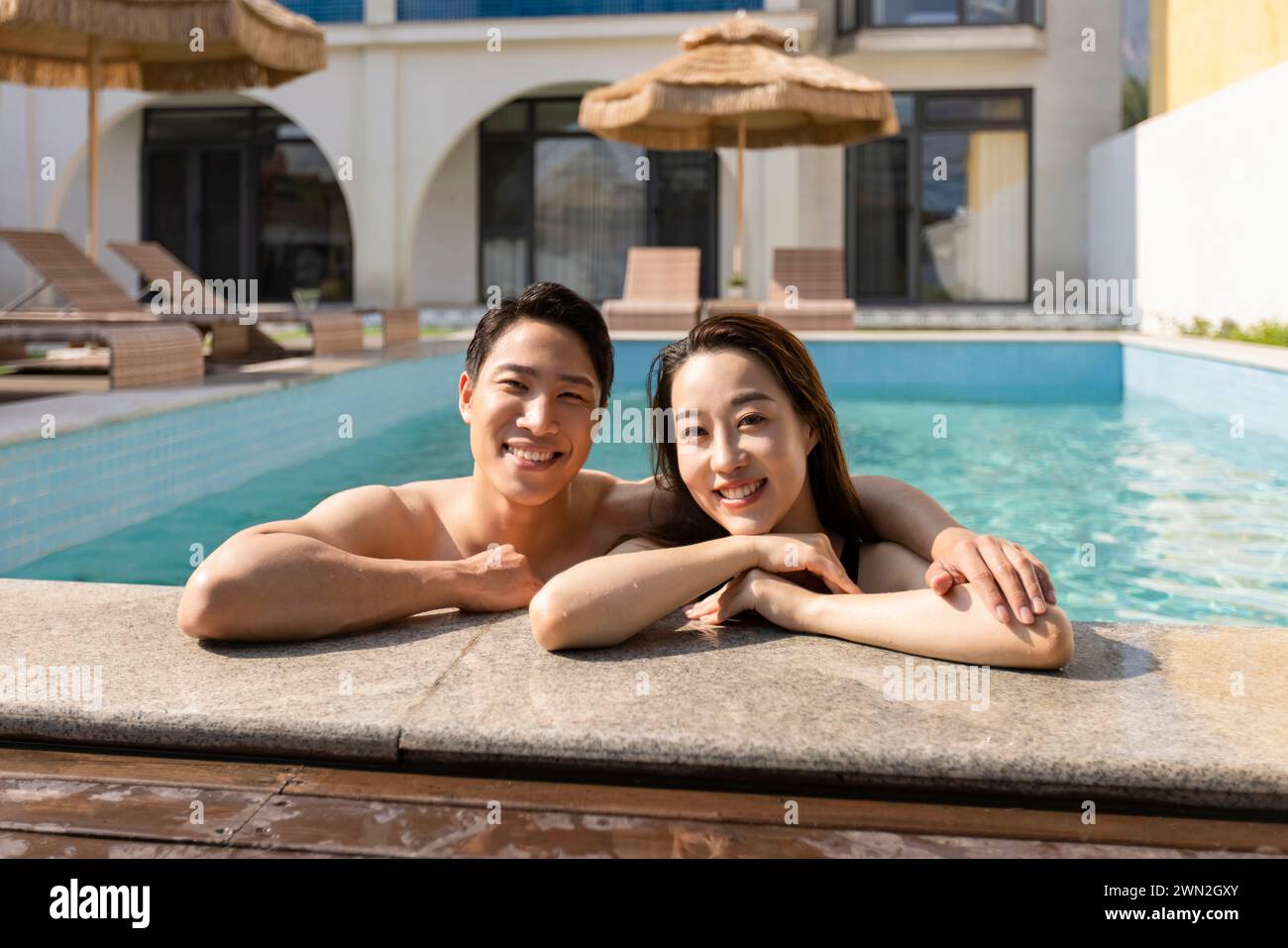 Happy young couple relaxing in swimming pool Stock Photo