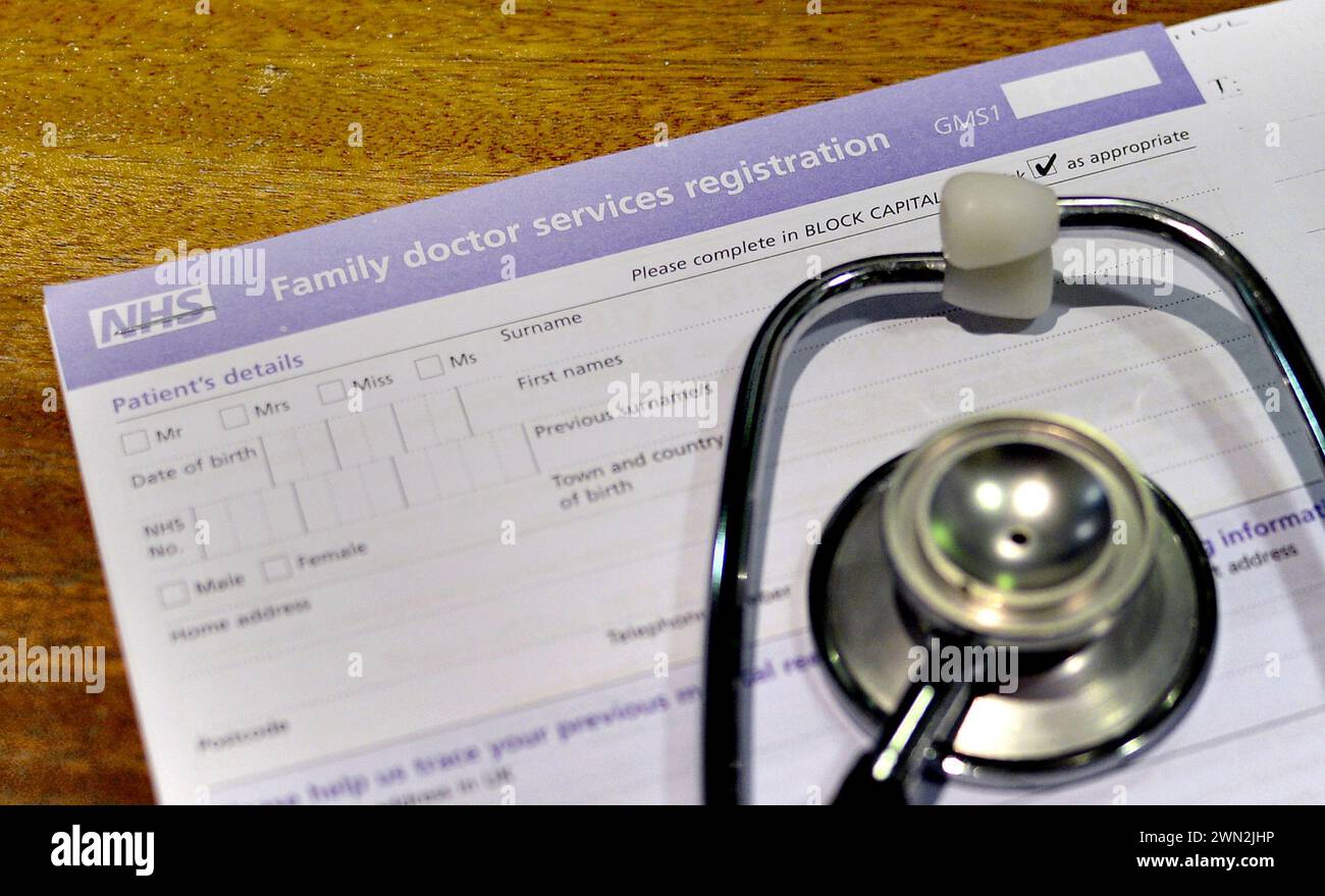 File photo dated 10/09/14 of a NHS family doctor services registration form and a stethoscope. A policy that could mean people having to travel if they want to see a GP for a same-day appointment has sparked concerns about patient safety and continuity of care in an area of London. Issue date: Thursday February 29, 2024. Stock Photo