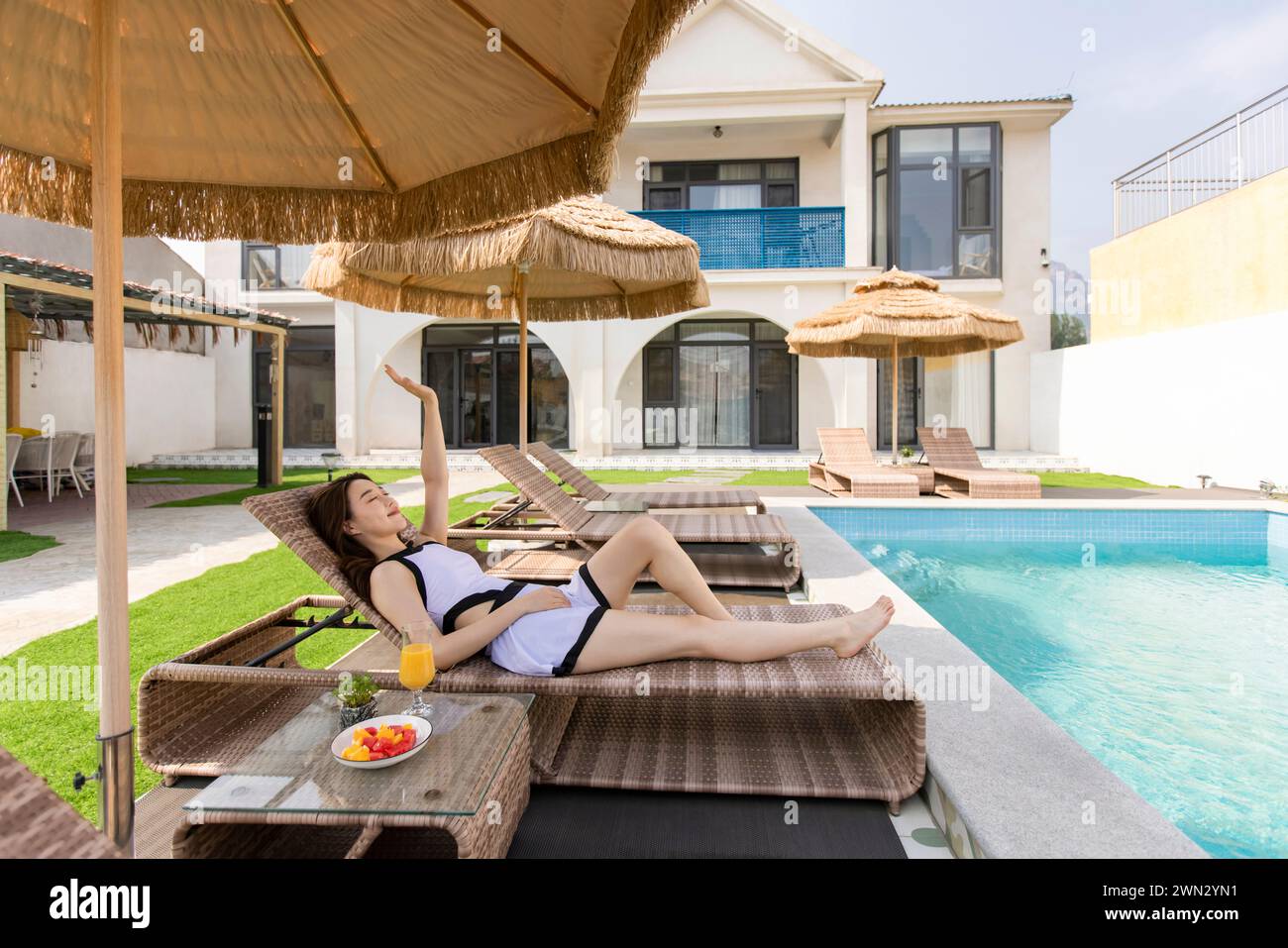 Young woman taking a rest on sun lounger Stock Photo
