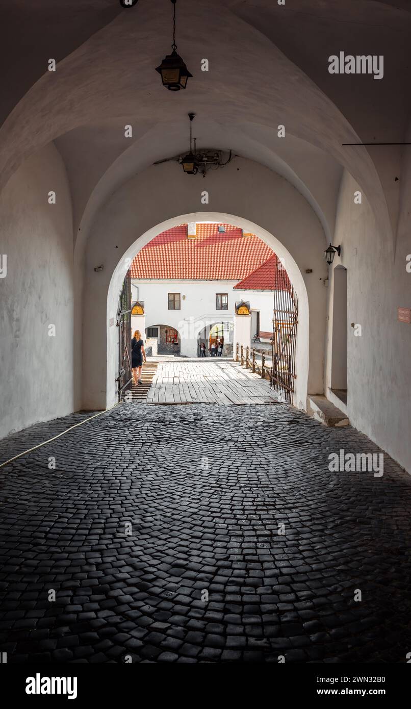 Gateway between courtyards of Palanok Castle. Fortified gateway with cobbled floor. Stock Photo