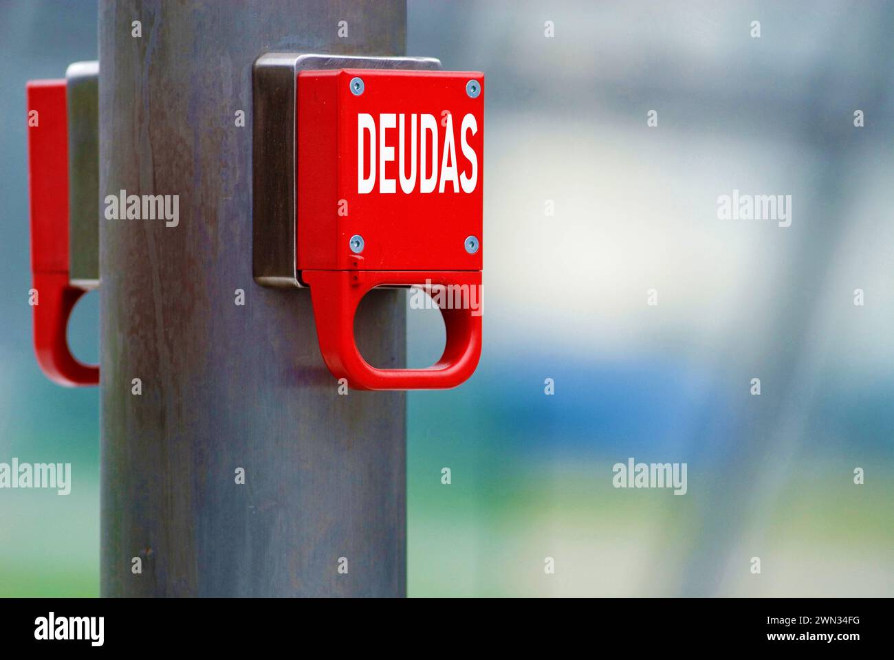 emergency brake with the spanish word deudas for debts, debt, ceiling, mountain, pile, reduction, burden Stock Photo