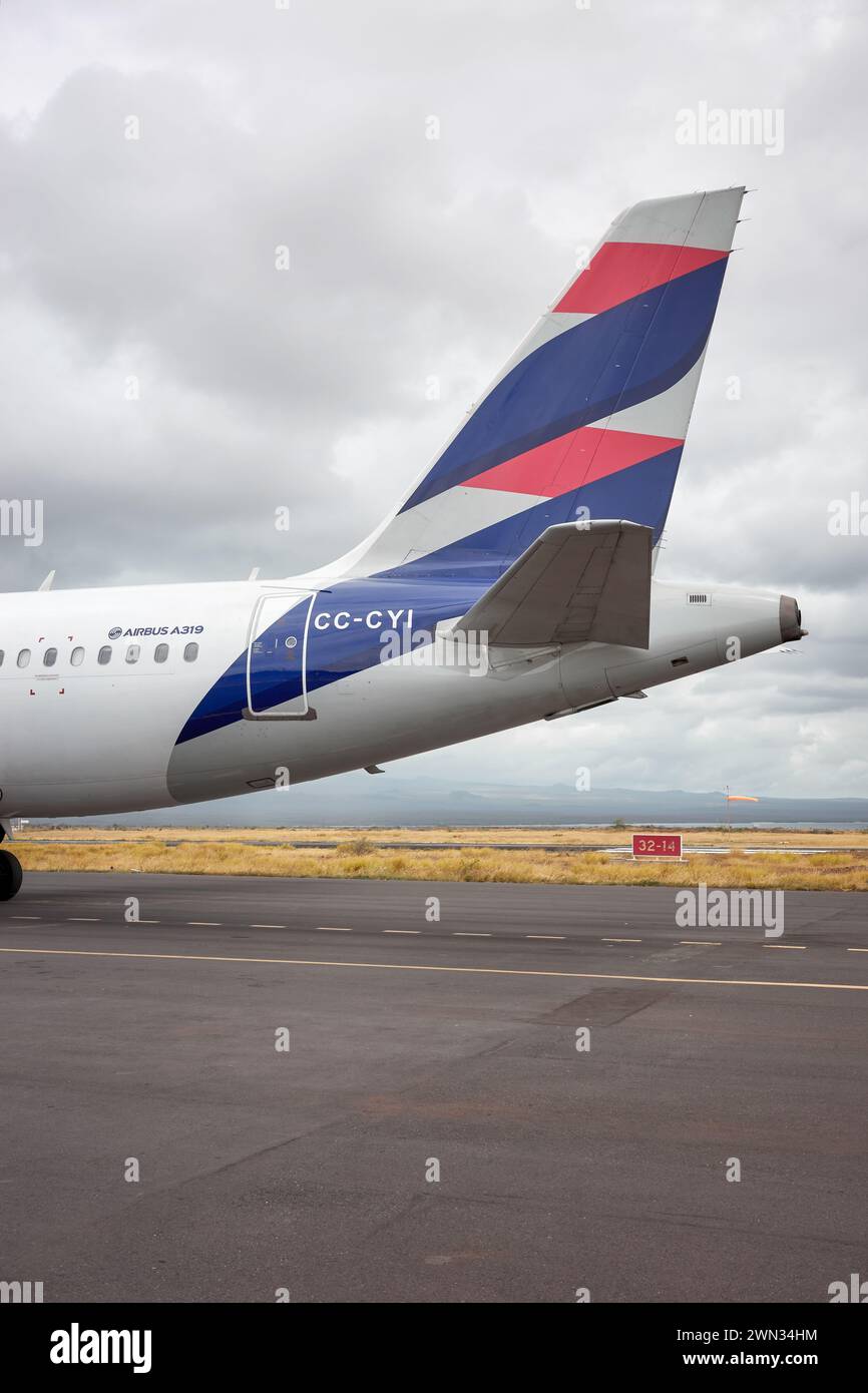 Baltra Island, Ecuador - July 12, 2023: Tail of a Latam Airlines Airbus A319 on the runway of Seymour Galapagos Ecological Airport. Stock Photo