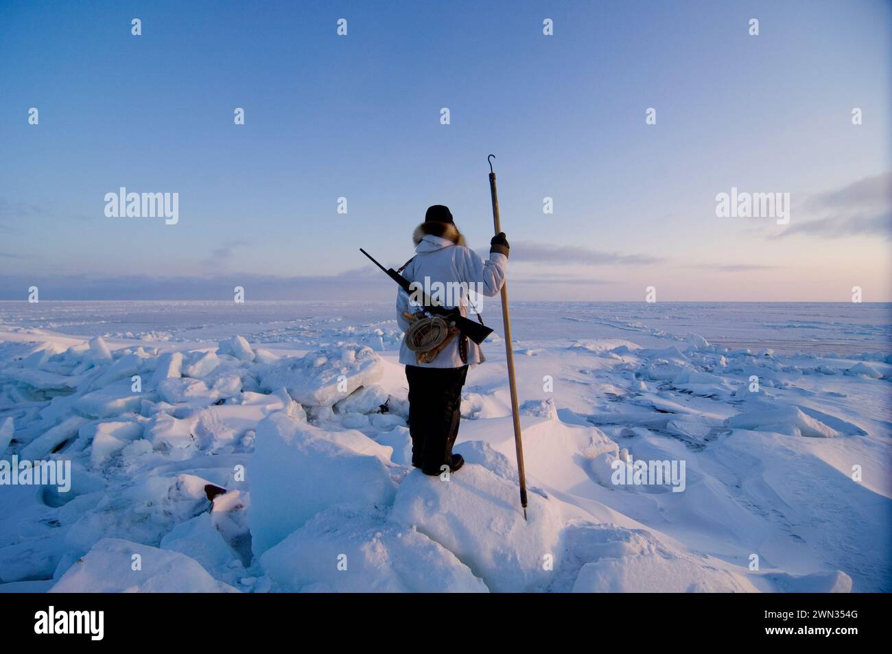 Inupiaq hunter seal hunting near open lead  at the point of Point Hope Tigia Arctic Alaska Stock Photo