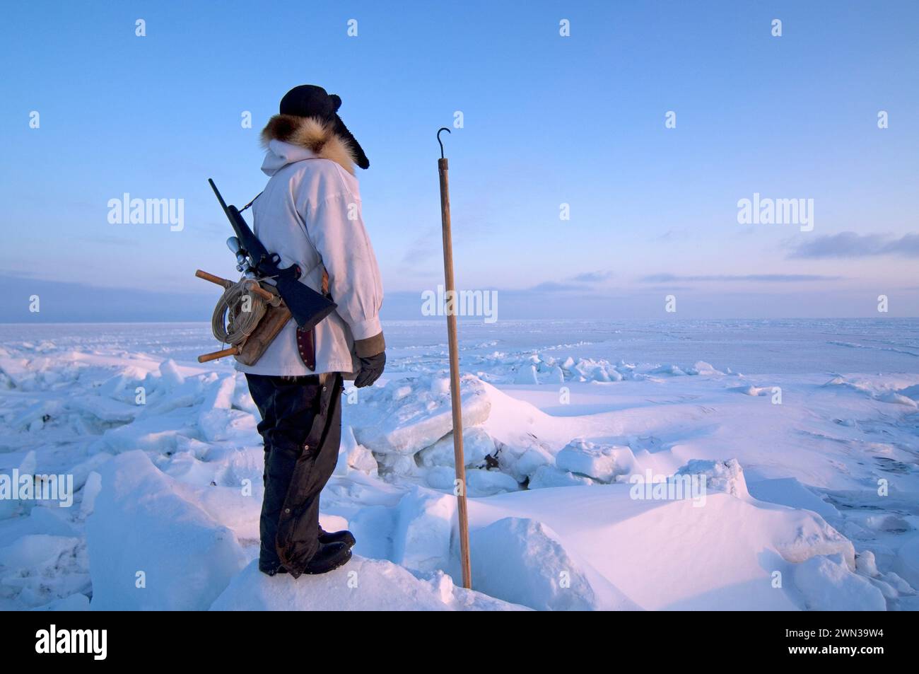 Inupiaq hunter seal hunting near open lead  at the point of Point Hope Tigia Arctic Alaska Stock Photo