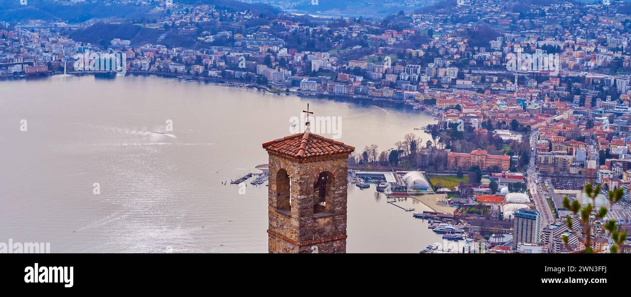 The old church's bell tower against Lugano Lake in purple sunset light, Castagnola, Lugano, Ticino, Switzerland Stock Photo