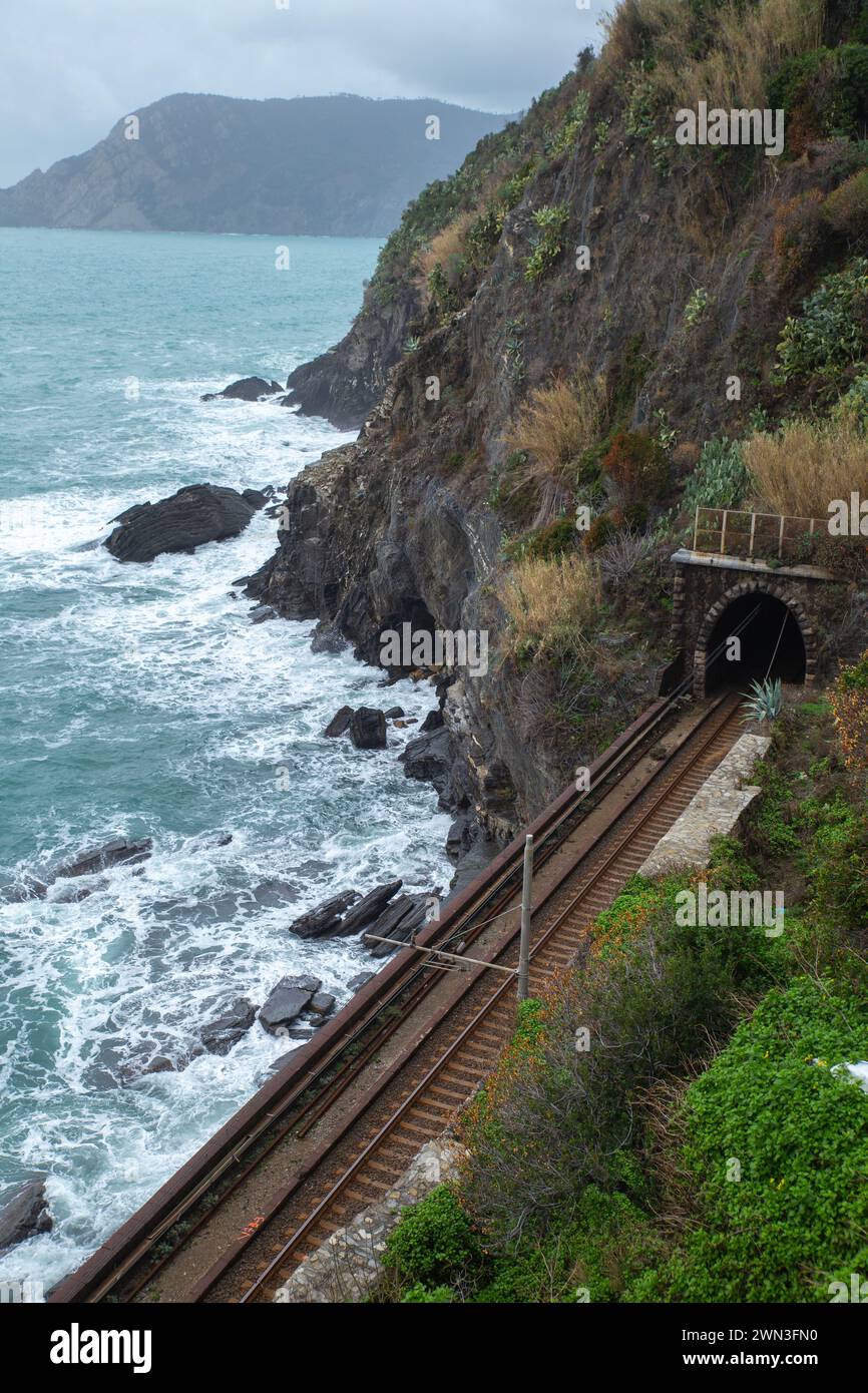 Overlook of the costal railway track with mountain and sea Stock Photo