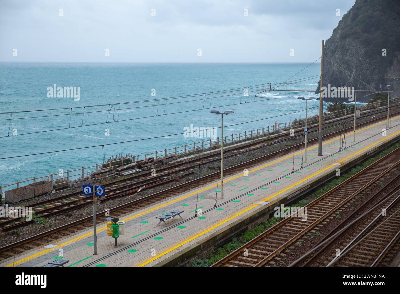 Overlook of the coastal railway track and platform with sea Stock Photo
