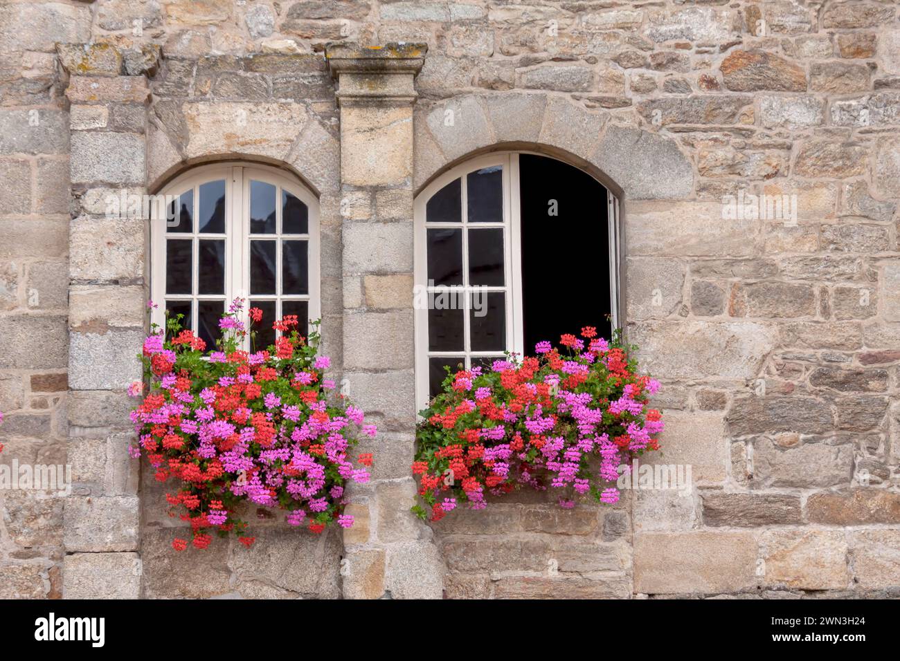 Two windows in a historic house, floral decoration, old town Guingamp, Departement Cotes-d'Armor, Brittany, France Stock Photo