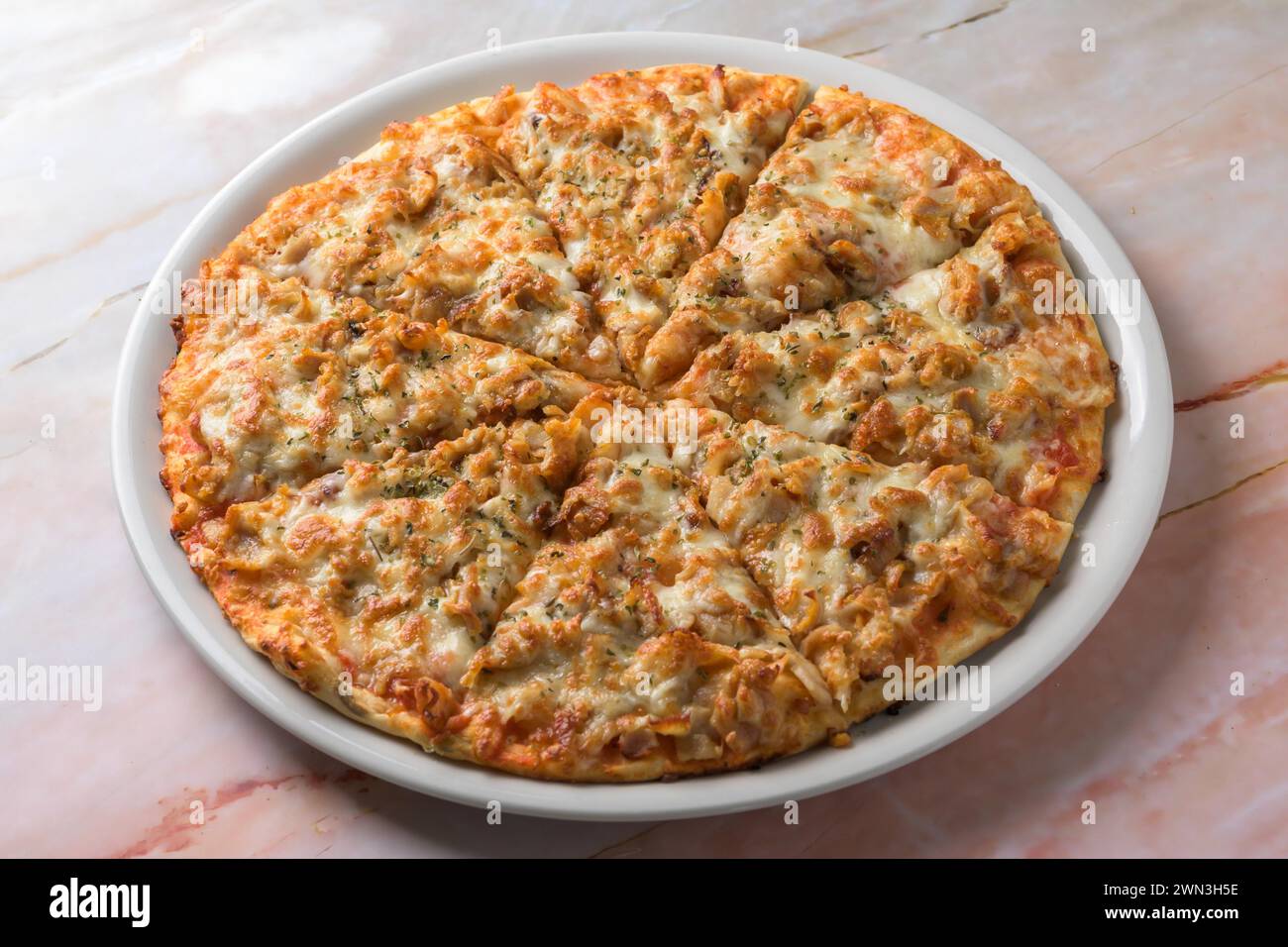 BBQ CHICKEN pizza isolated on cutting board top view on dark background italian fast food, mallorca, balearic islands, spain Stock Photo