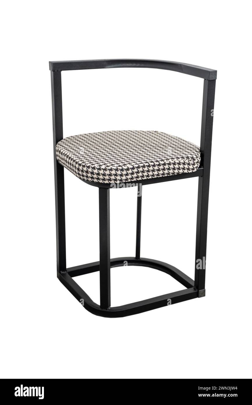 Black and white checkered upholstered stool on metal frame Stock Photo