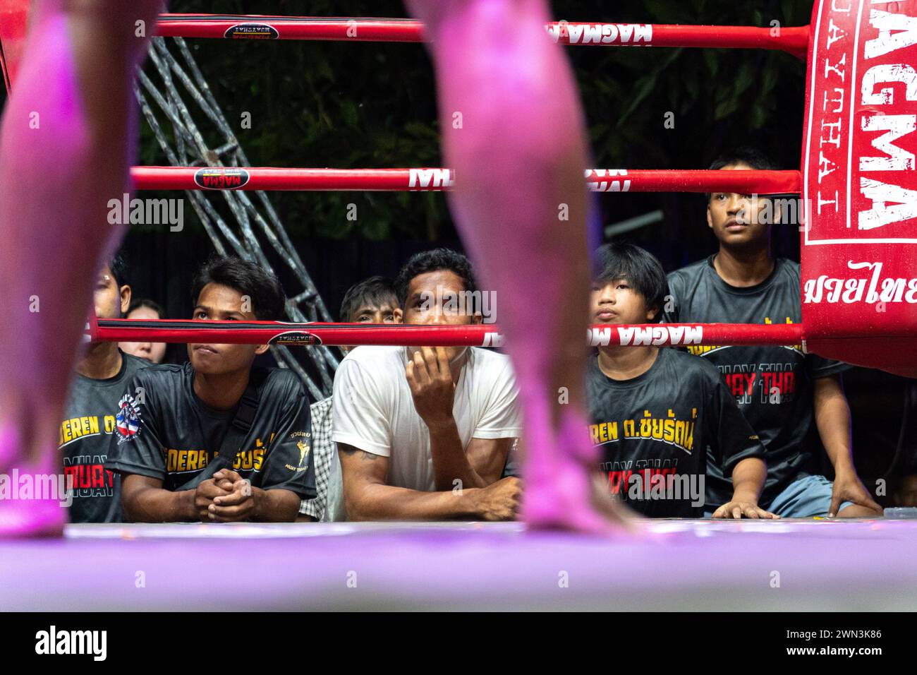 Koh Chang, Thailand. 24th Feb, 2024. Spectators watch boxers in fight, during the Muay Thai