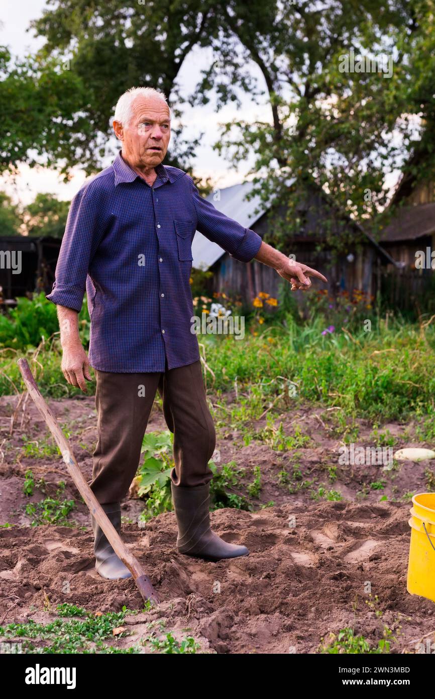 Elderly man digging earth hi-res stock photography and images - Alamy