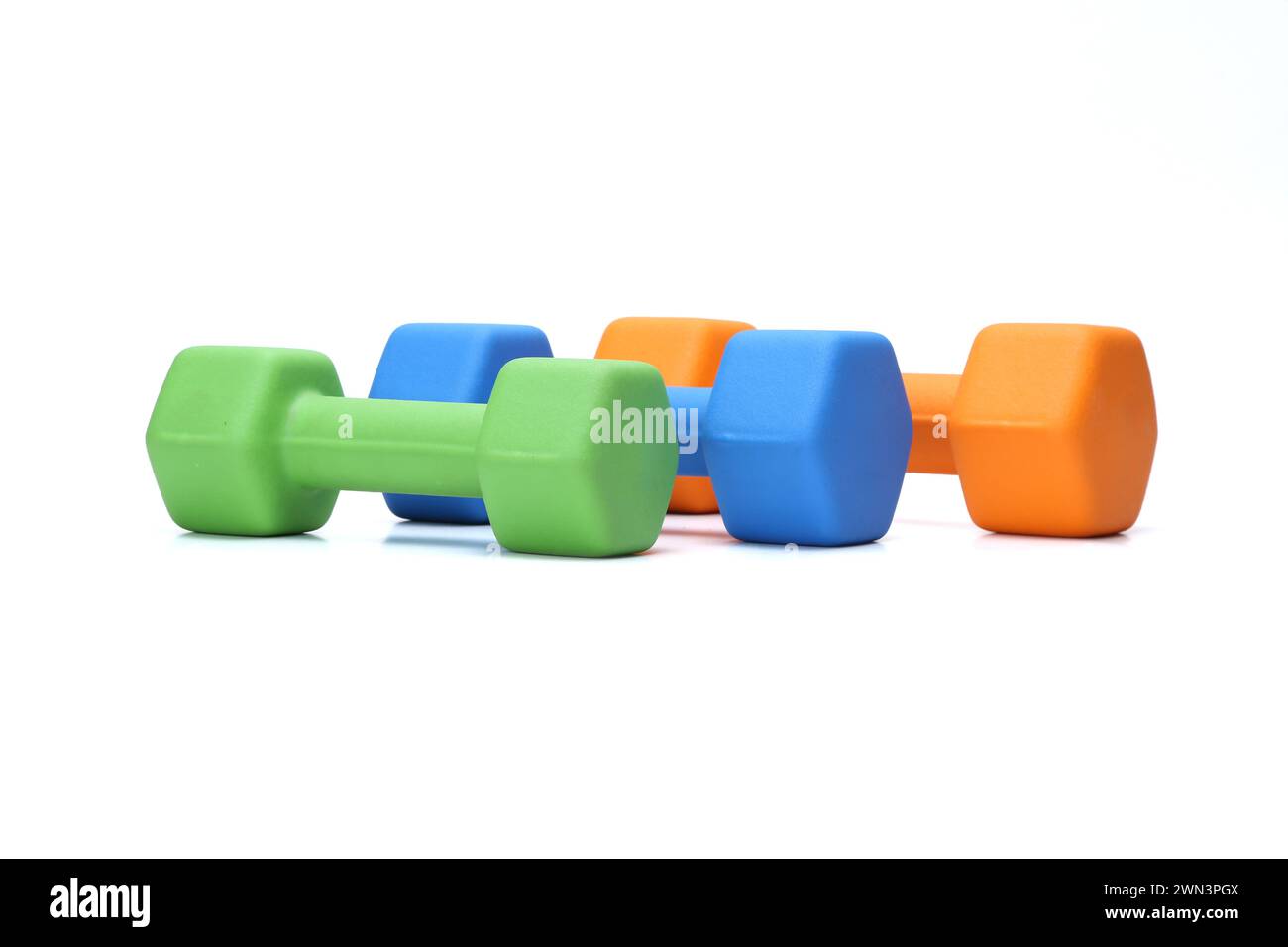 colorful rubber coated dumbbells isolated on white background Stock Photo