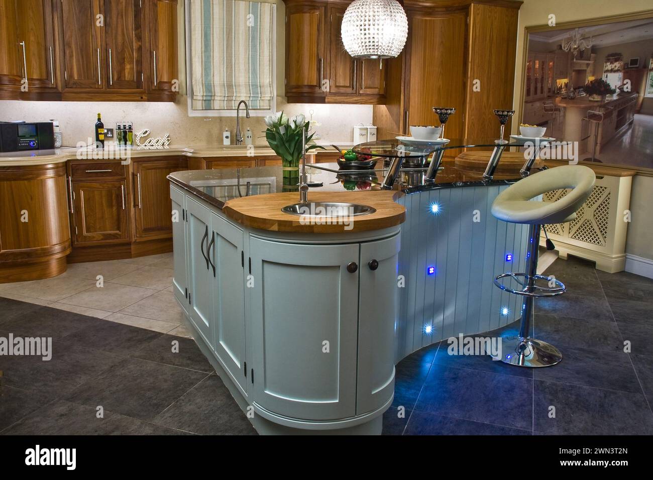 Contemporary kitchen with island in modern style with extractor fan