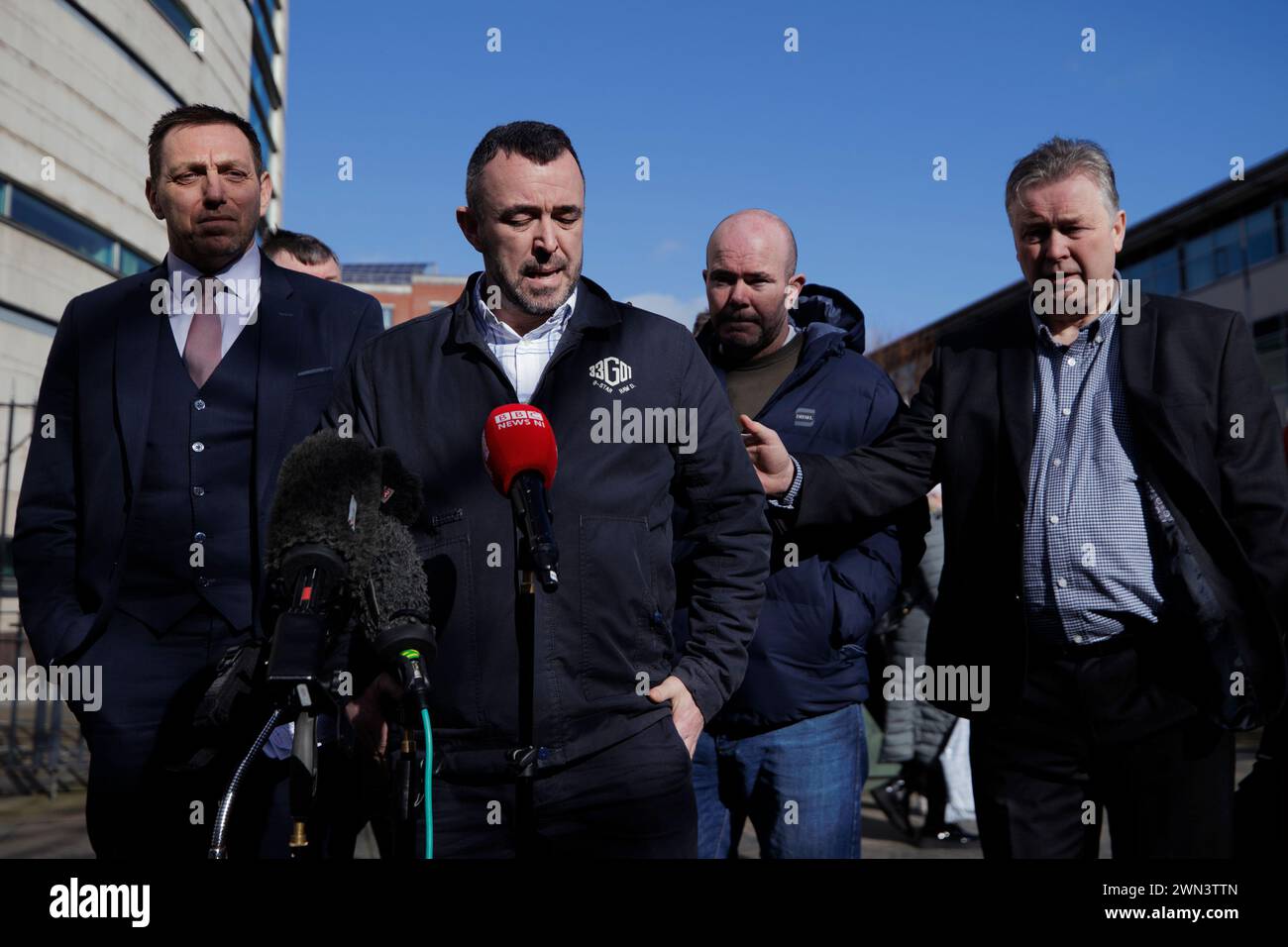 Kieran Fox (second from left), son of Eamon Fox, is comforted during a
