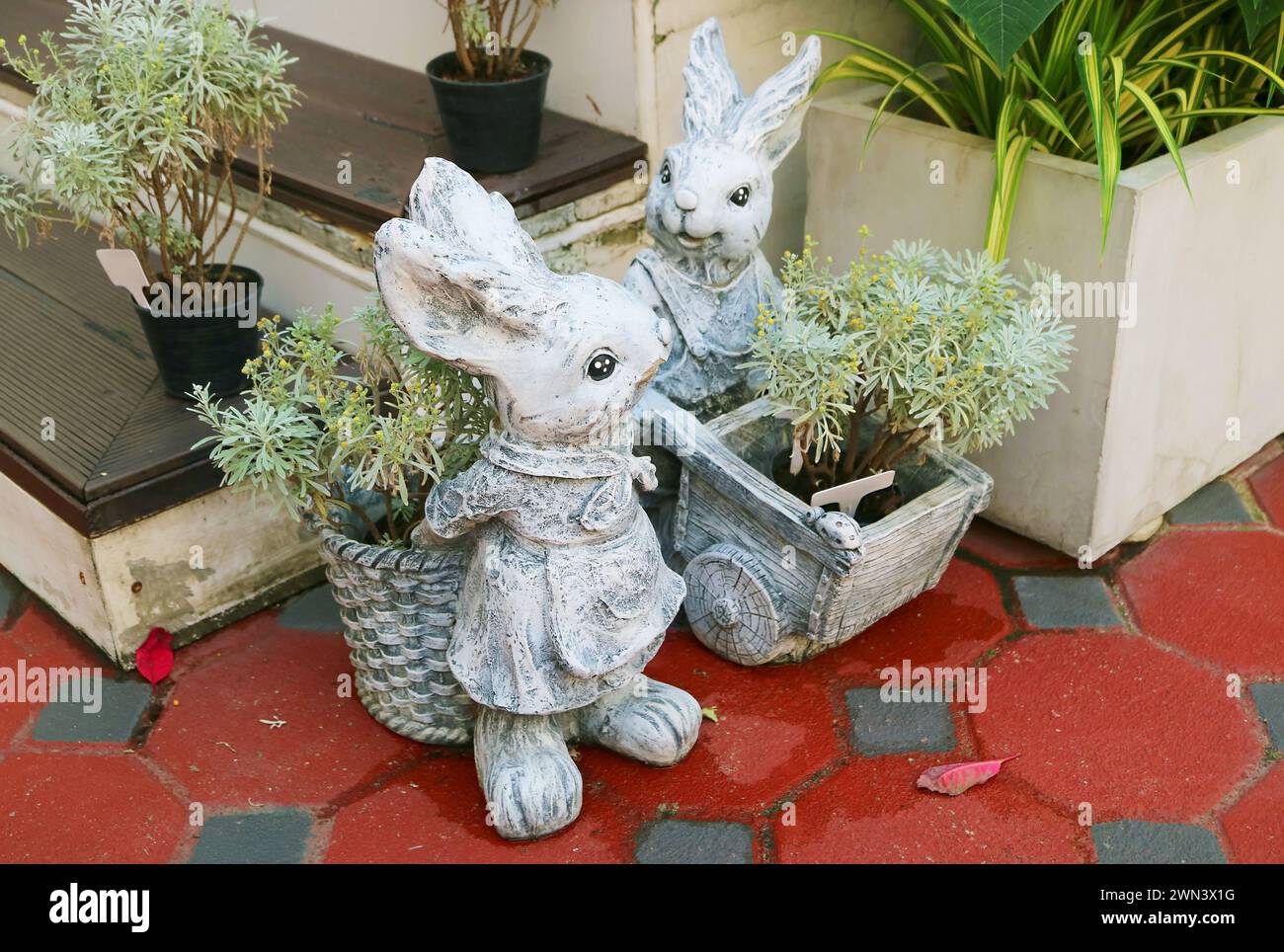 Pair of Adorable Stone Easter Bunny Sculptures in the Patio Stock Photo