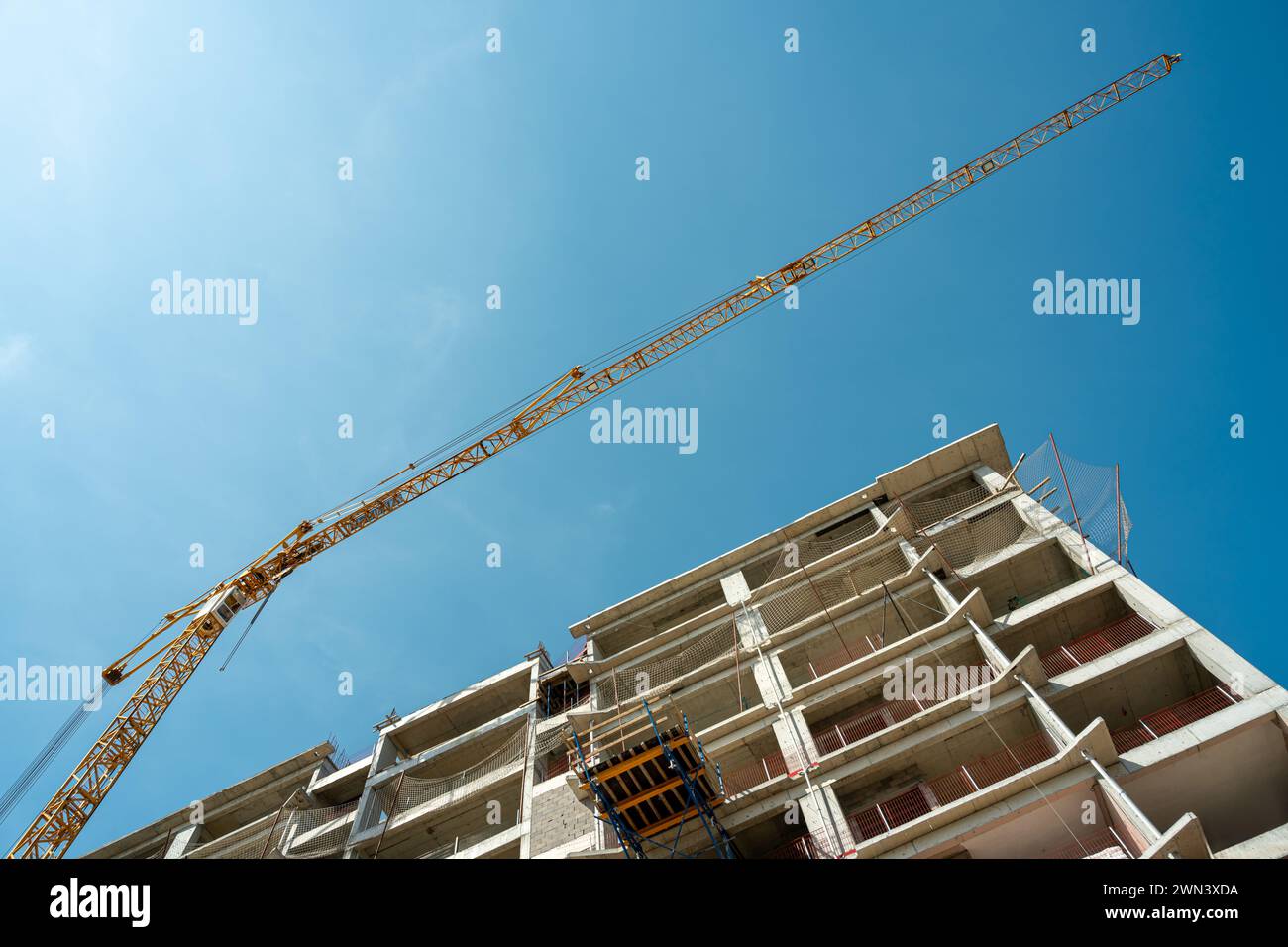 Construction crane working on large construction site Stock Photo