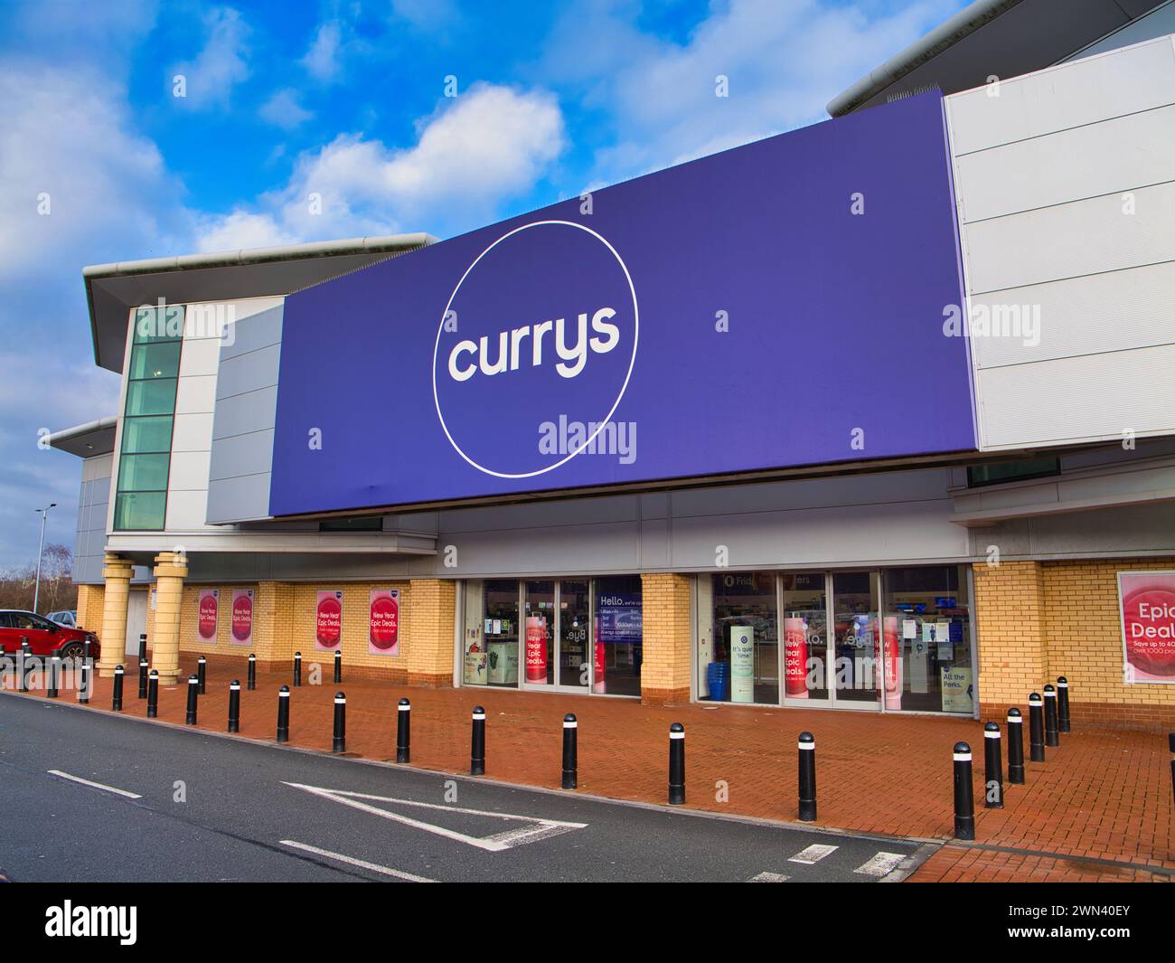 St Helens, UK - Jan 4 2024: Corporate signage and the customer entrance at a Currys superstore in St Helens, Merseyside, England, UK. Stock Photo