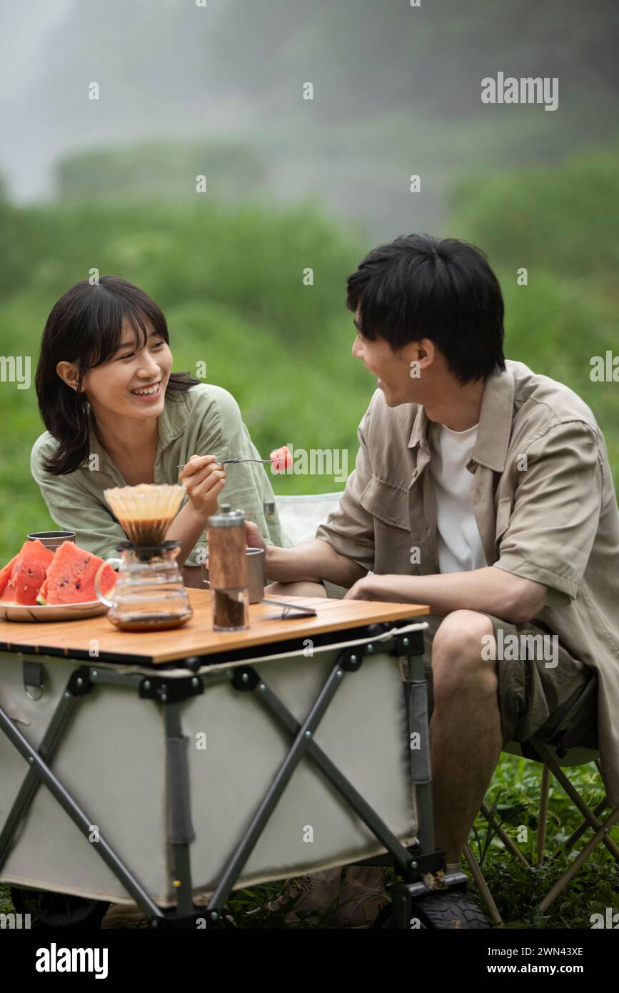 Young couple picnicking outdoors Stock Photo