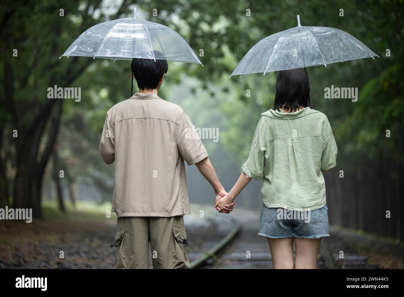 Young couple holding umbrellas Stock Photo