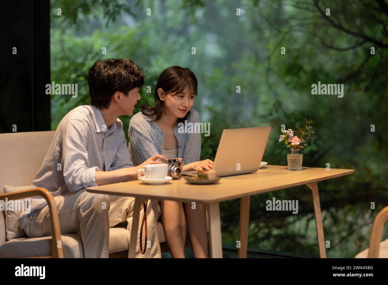 Young couple using laptop in café Stock Photo