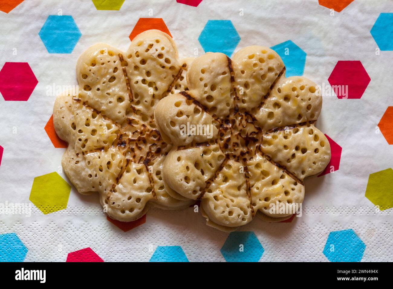 Blooming Lovely Crumpets light fluffy flower shaped crumpets from M&S on serviette napkin Stock Photo