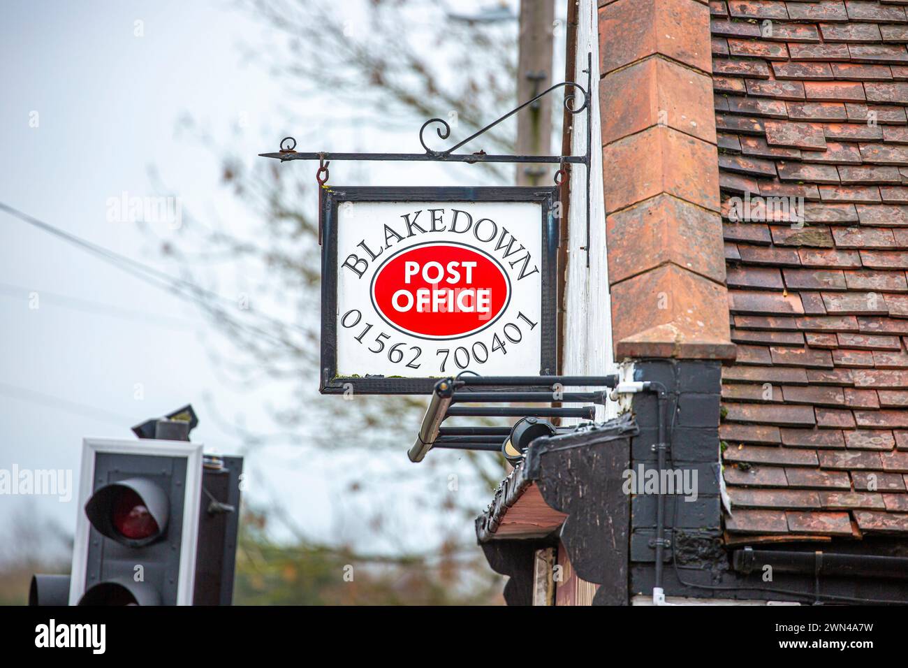 Post office sign hanging on the side of an old building. Stock Photo