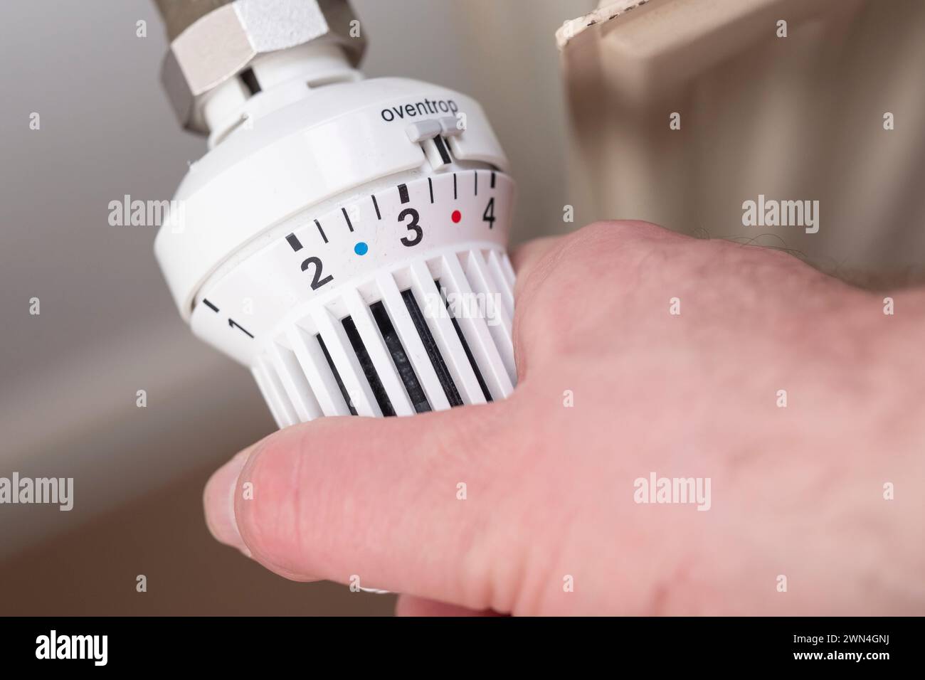 Hand on a radiator valve Stock Photo