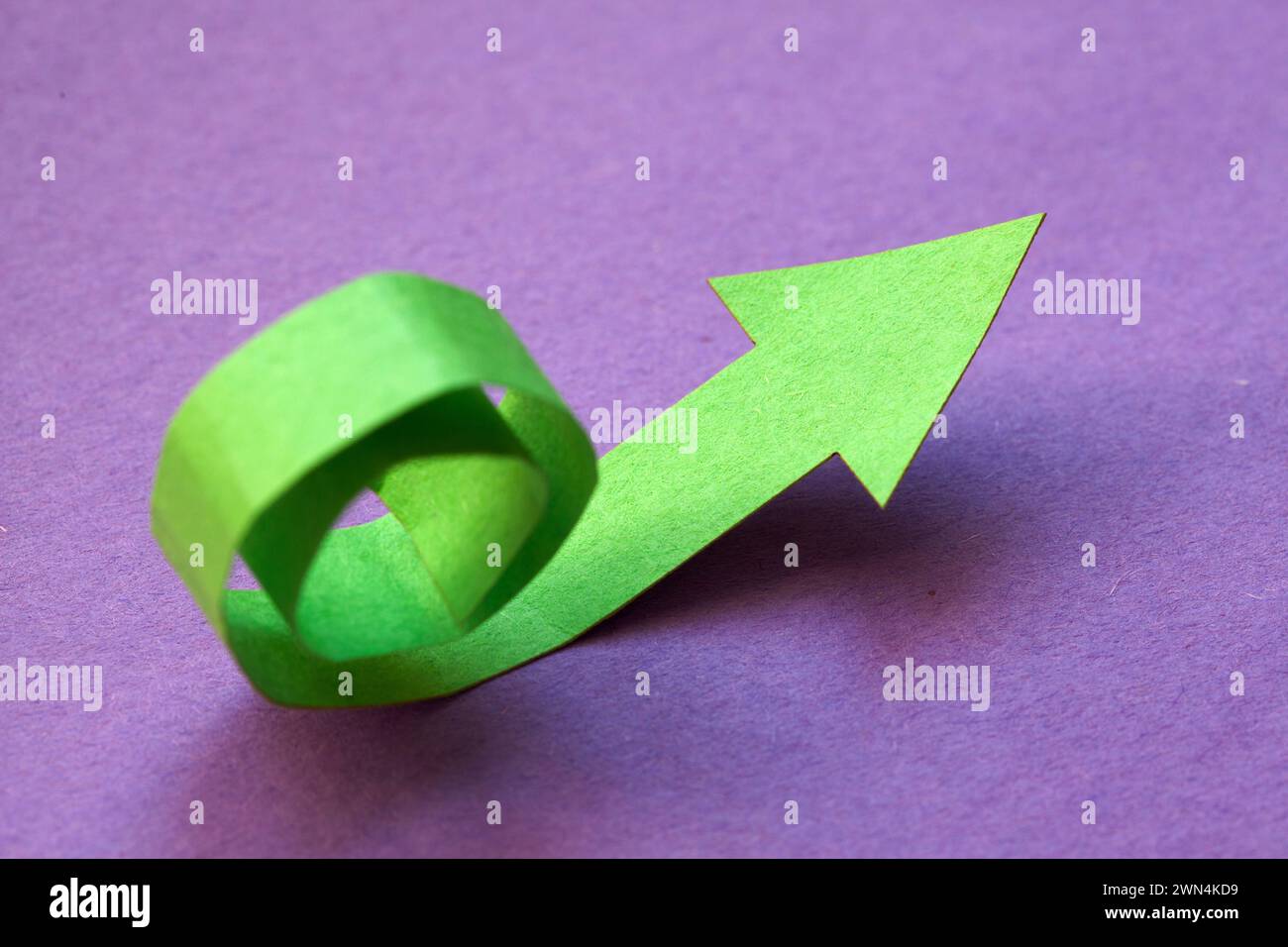 unfolding trend showing exponential growth, green paper arrow Stock Photo