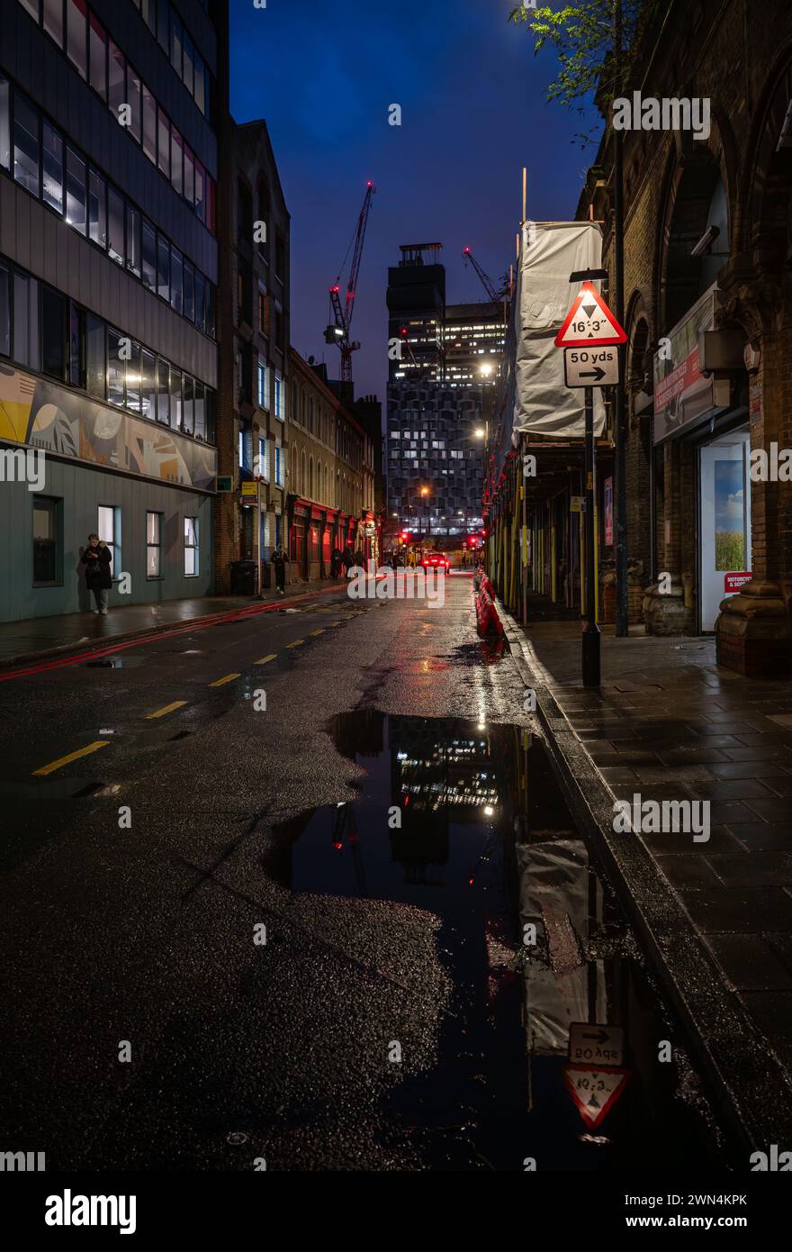 Bermondsey, London, UK: View along Crucifix Lane towards Guy's Hospital at night in the London borough of Southwark. Stock Photo
