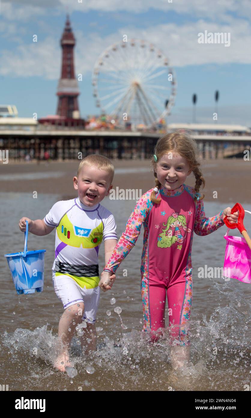 30/06/15  Cristin (5) and Daryl (2) Anderson. After a morning of cloud,  hot sunny weather finally arrived arrived at lunchtime today.  All Rights Re Stock Photo