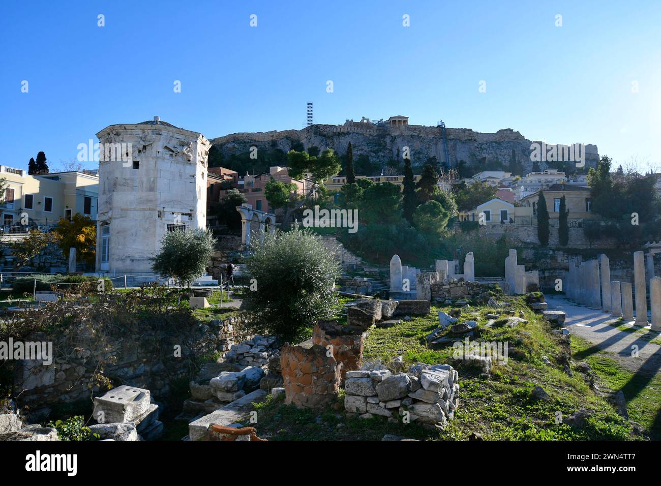 Athens, Greece - December18, 2023: The historic octagonal so-called Tower of the Winds with reliefs of weather gods, made of marble, Akropolis hill in Stock Photo