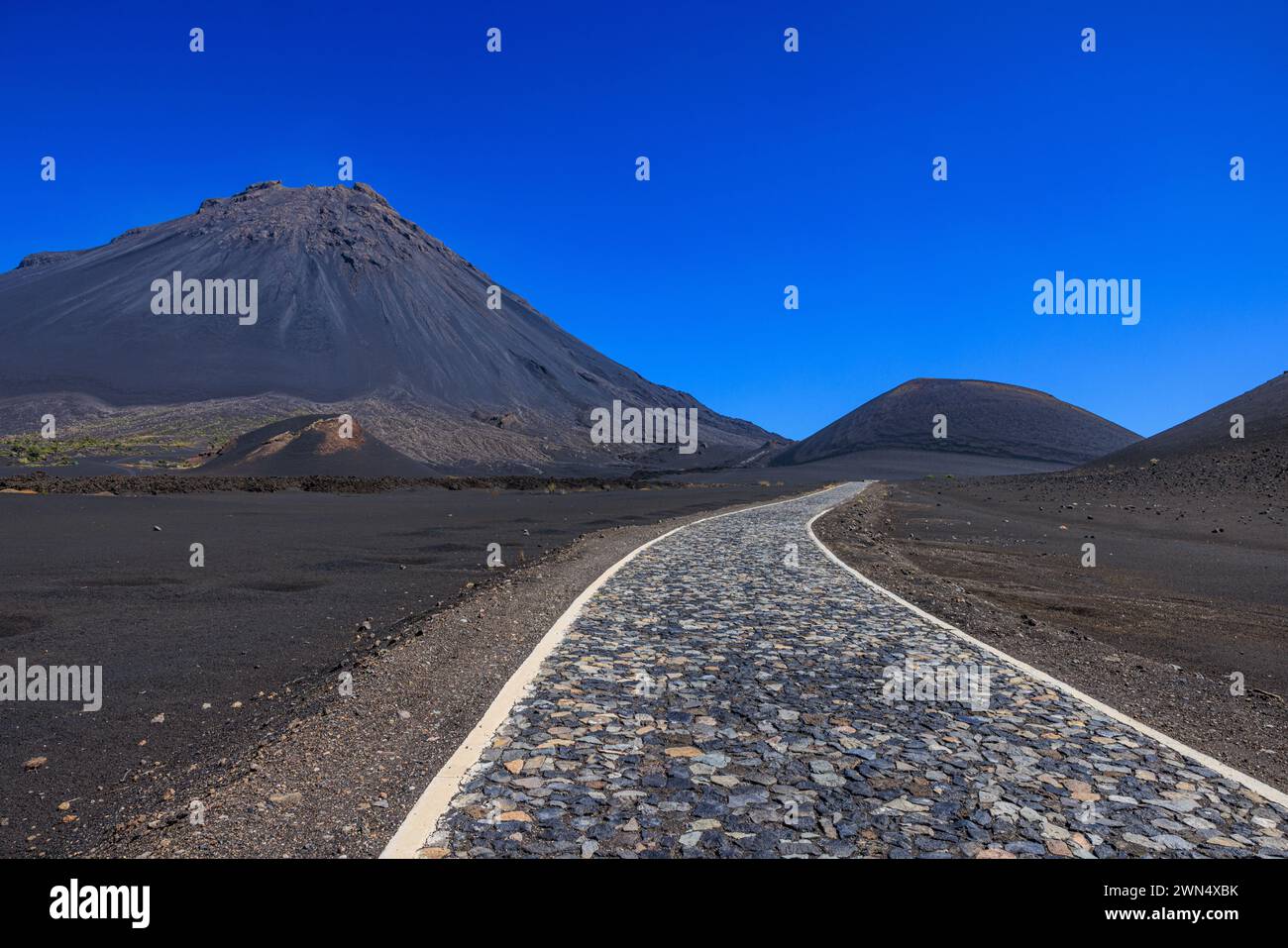 a cobbled road crossing the flat black lava caldera of fogo island ...