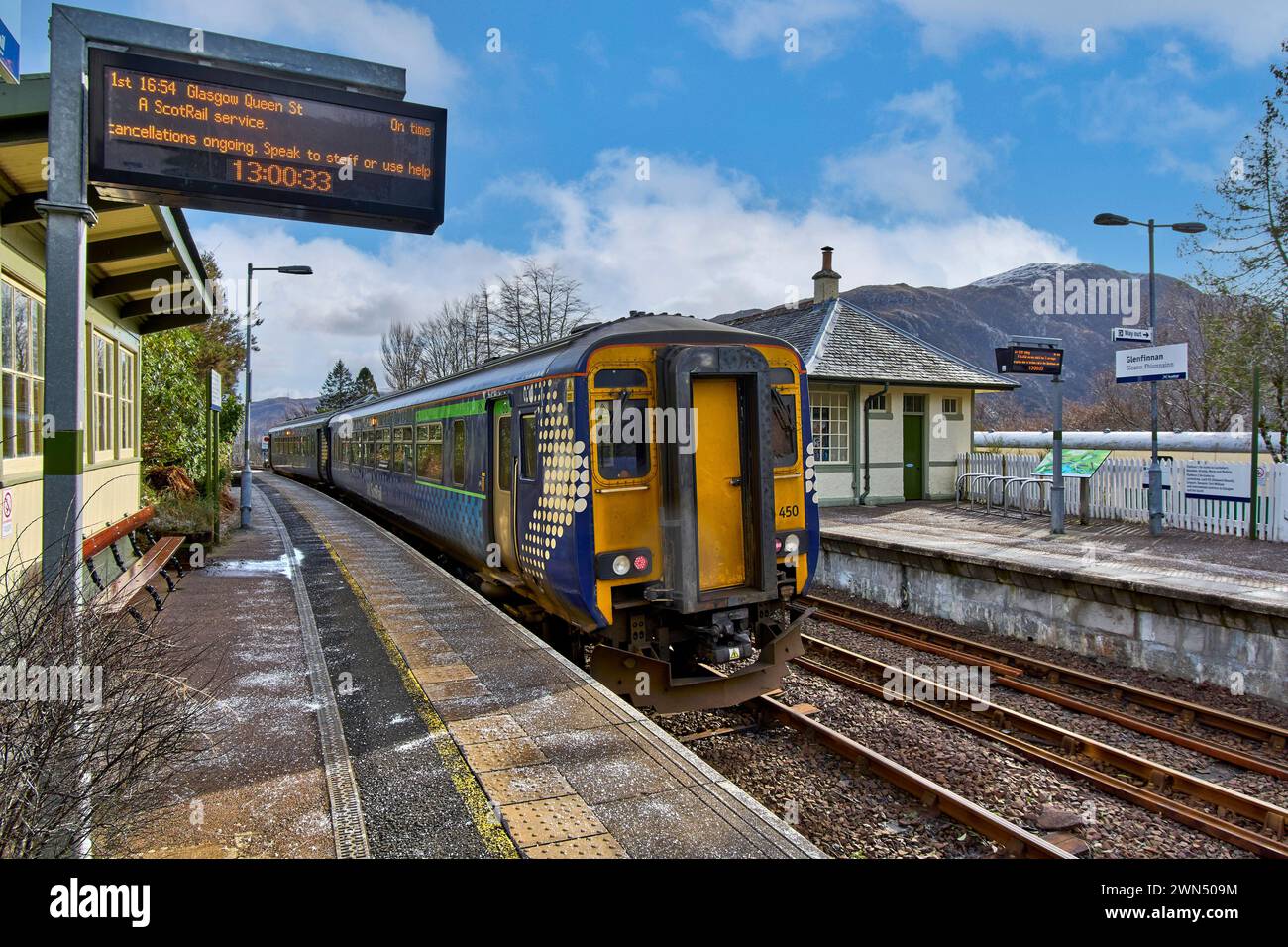 Glenfinnan Railway Station a ScotRail Train waiting at the platform journey details on the electronic notice board Stock Photo