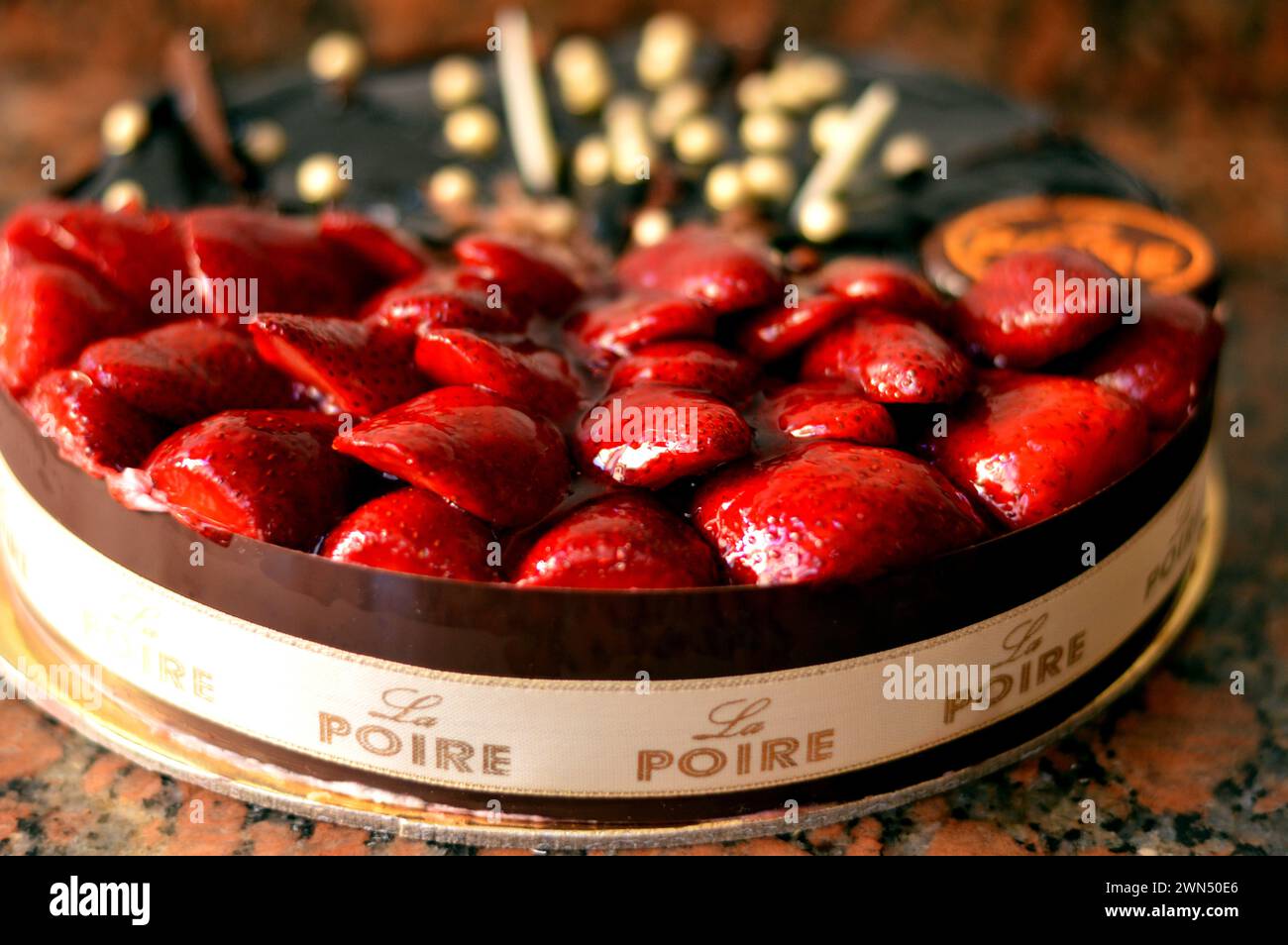 Cairo, Egypt, February 28 2024: La Poire Traditions of French patisseries and Egyptian baking roots, a half chocolate and half strawberry fruit and wh Stock Photo