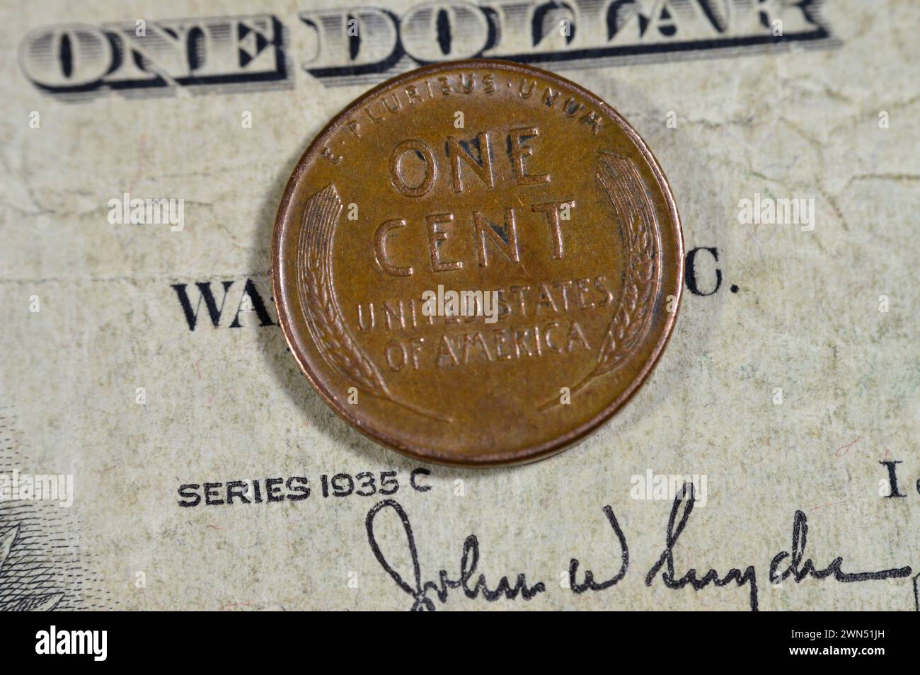 Two wheat ears surrounding lettering on the reverse side of One American cent coin series 1957, Obverse side features Abraham Lincoln the 16th preside Stock Photo