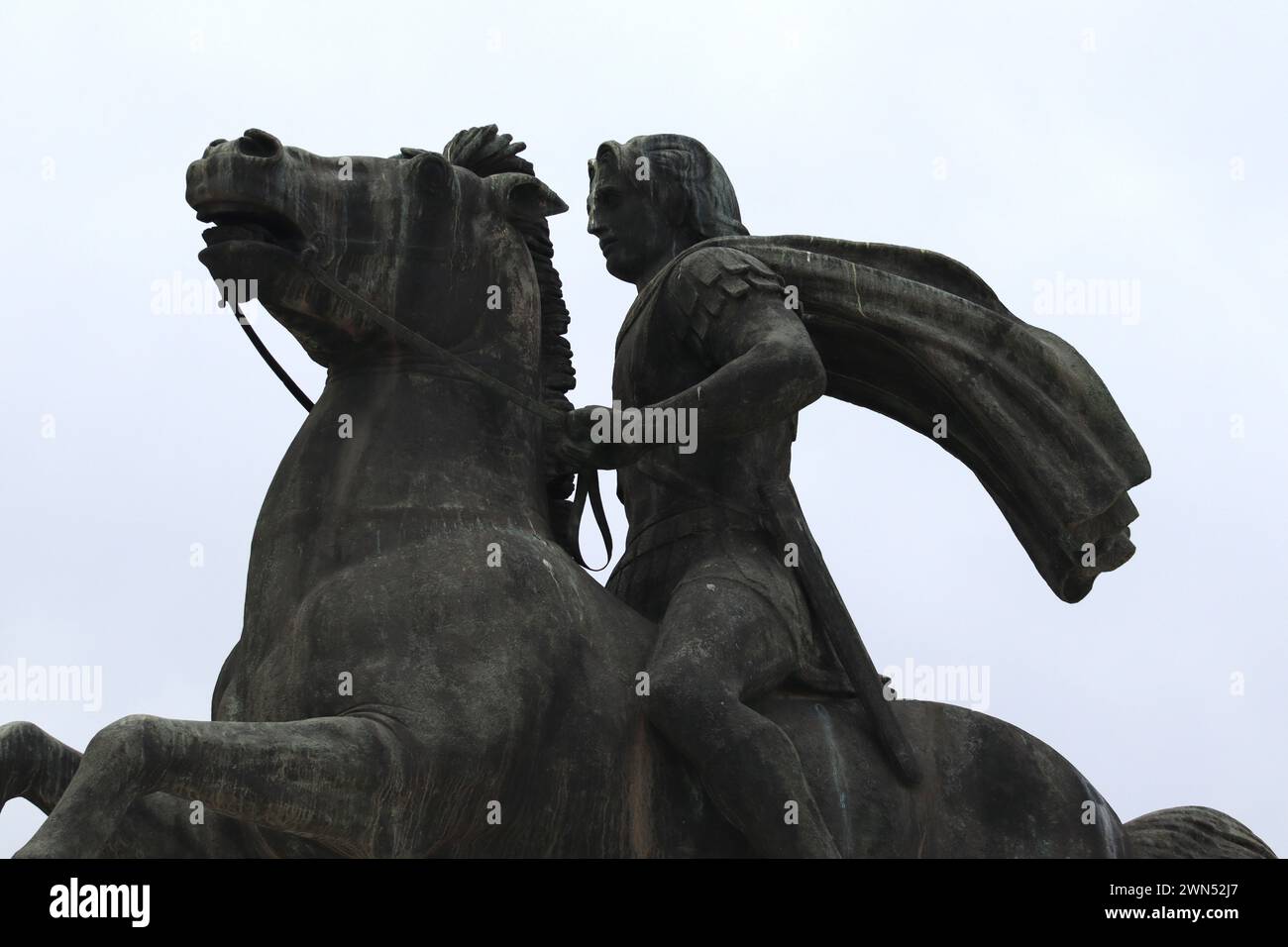 Conquest amidst the clouds. Alexander the great and bucephalus. White sky as background. Stock Photo