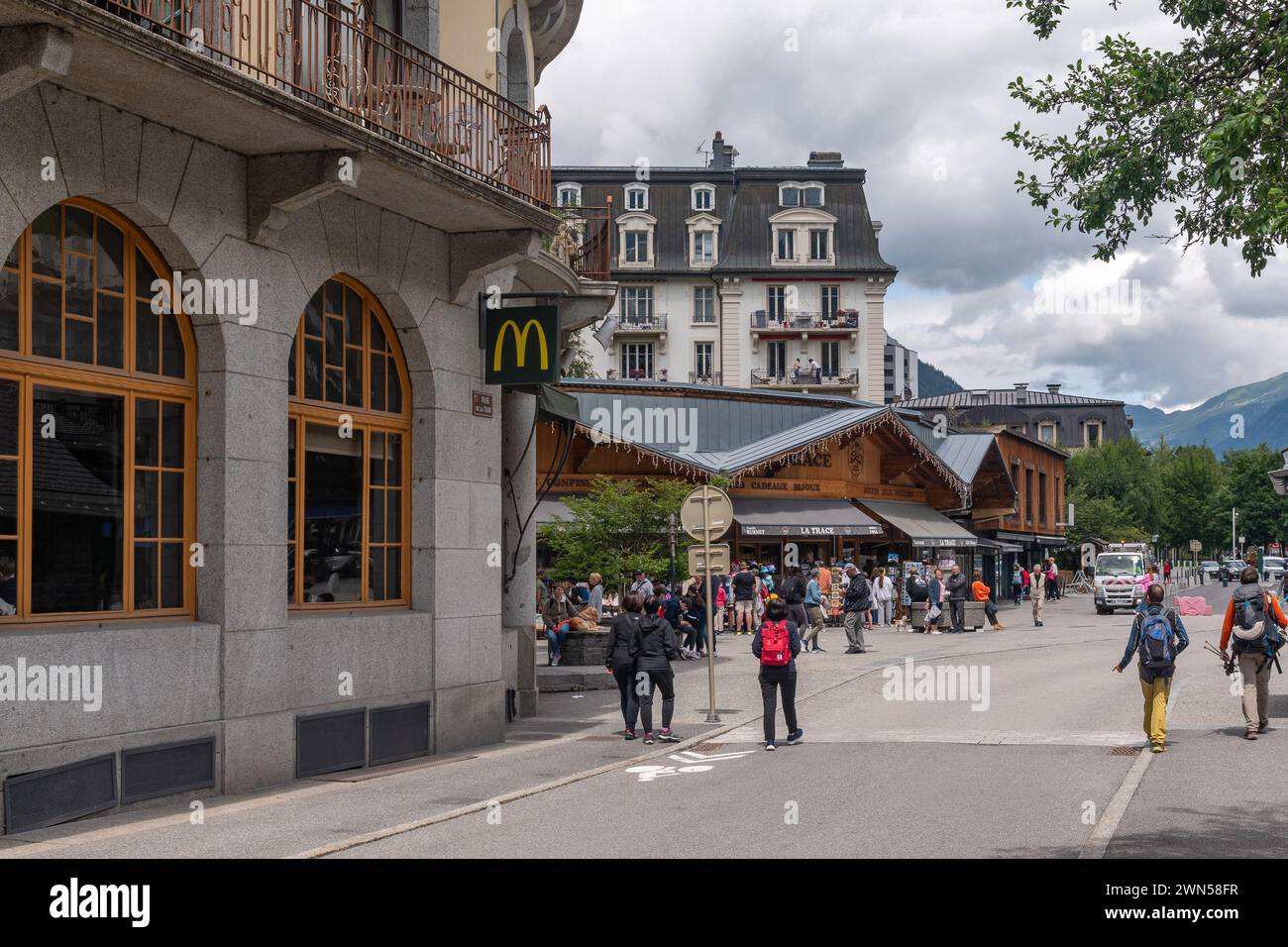 Exterior of a McDonald's fast food restaurant in the centre of the alpine town with hikers, Chamonix, Haute Savoie, Auvergne Rhone Alpes, France Stock Photo