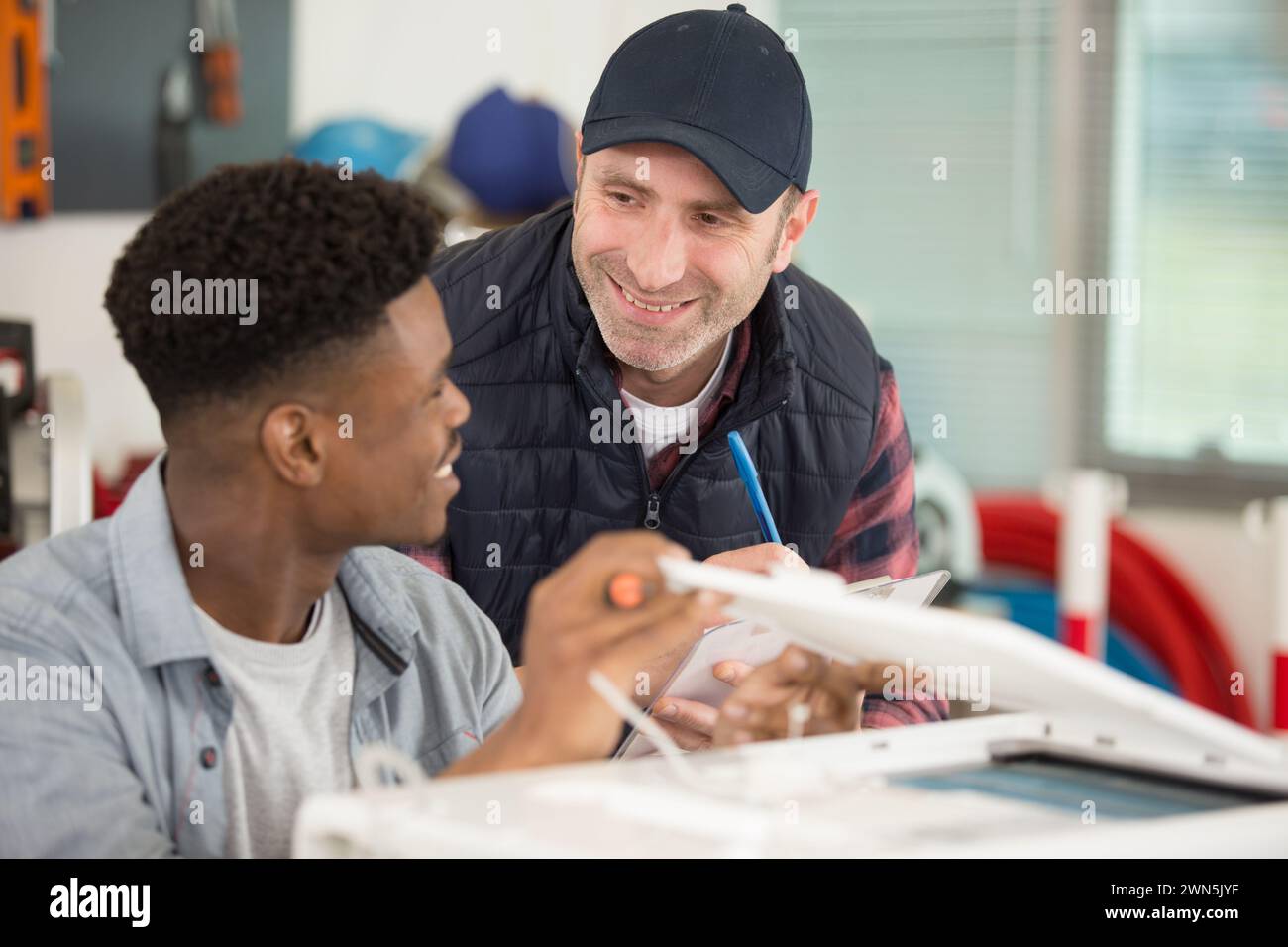 supervisor and apprentice in friendly communication Stock Photo