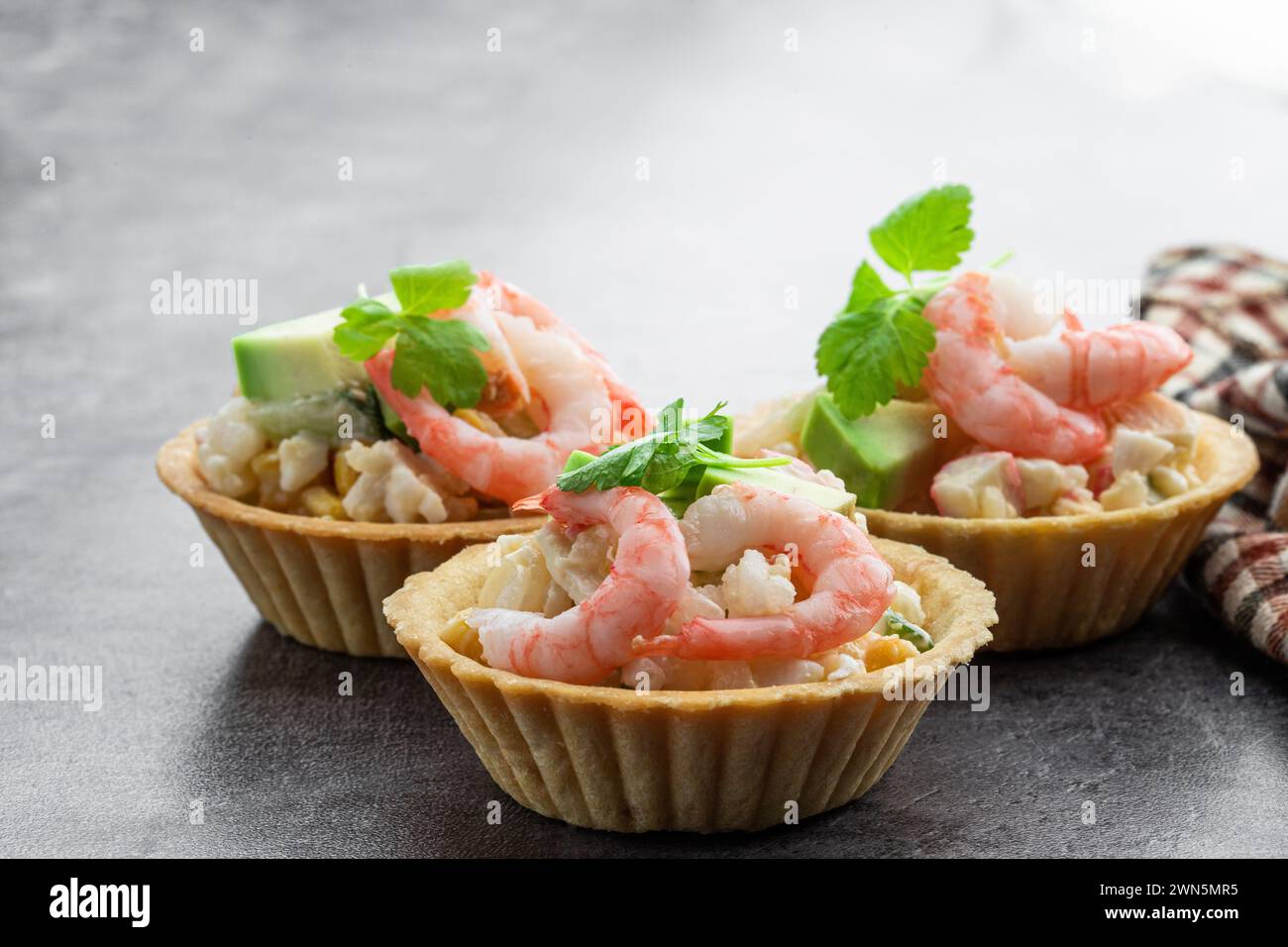 Shrimp and cheese salad tartlets appetizer on gray background Stock