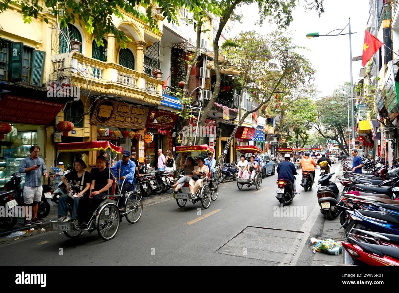 Extremely busy streets in old town of Hanoi, with bikes and food ...