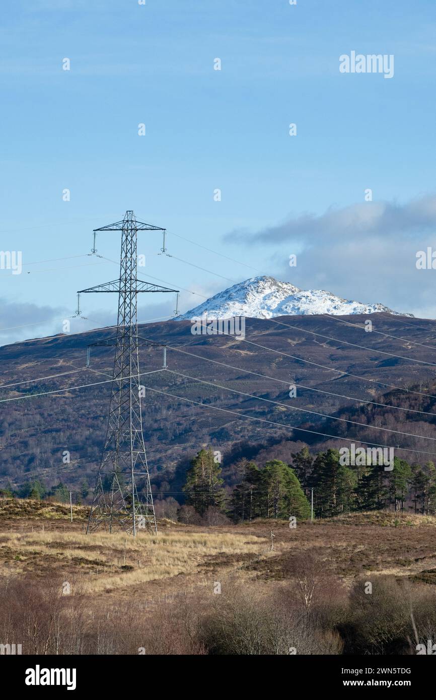 Visual impact of electricity pylons and cables on Ben Venue, as seen from the Great Trossachs Path, Loch Lomond and the Trossachs National Park Stock Photo