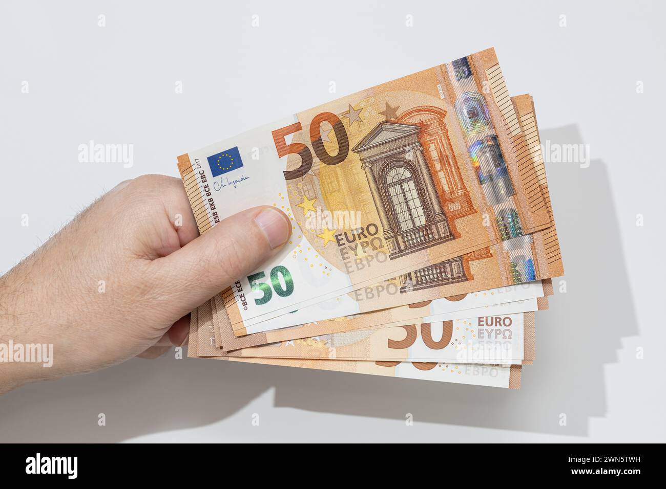Hand holding many fifty euro banknotes on white background Stock Photo ...