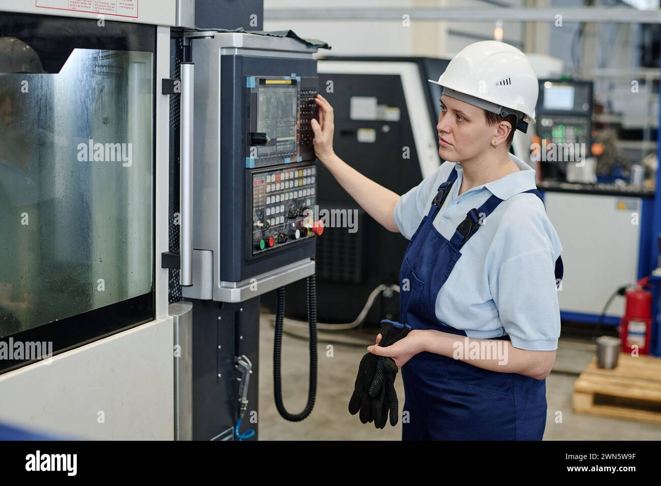 Worker wearing helmet uniform hi-res stock photography and images - Alamy