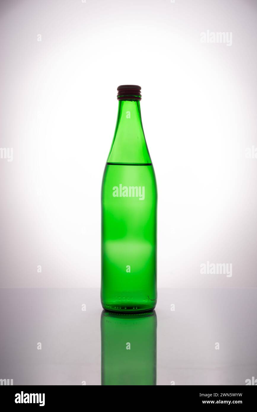 green bottle of mineral water on white background. Stock Photo