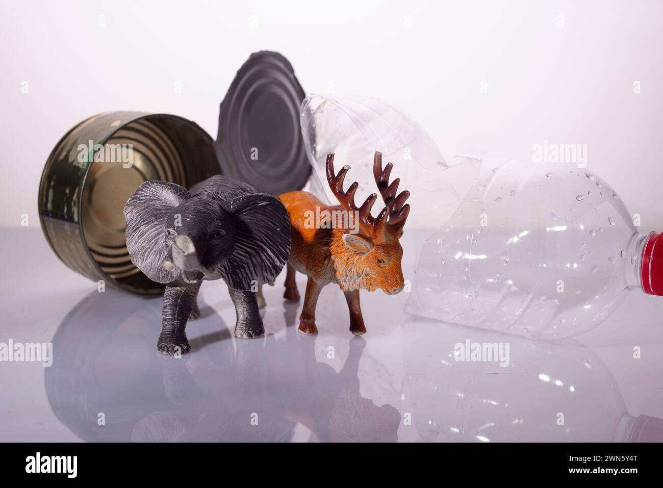 plastic pollution concept harm to animals. Animal toys with plastic, metal and glass on a white background installation Stock Photo
